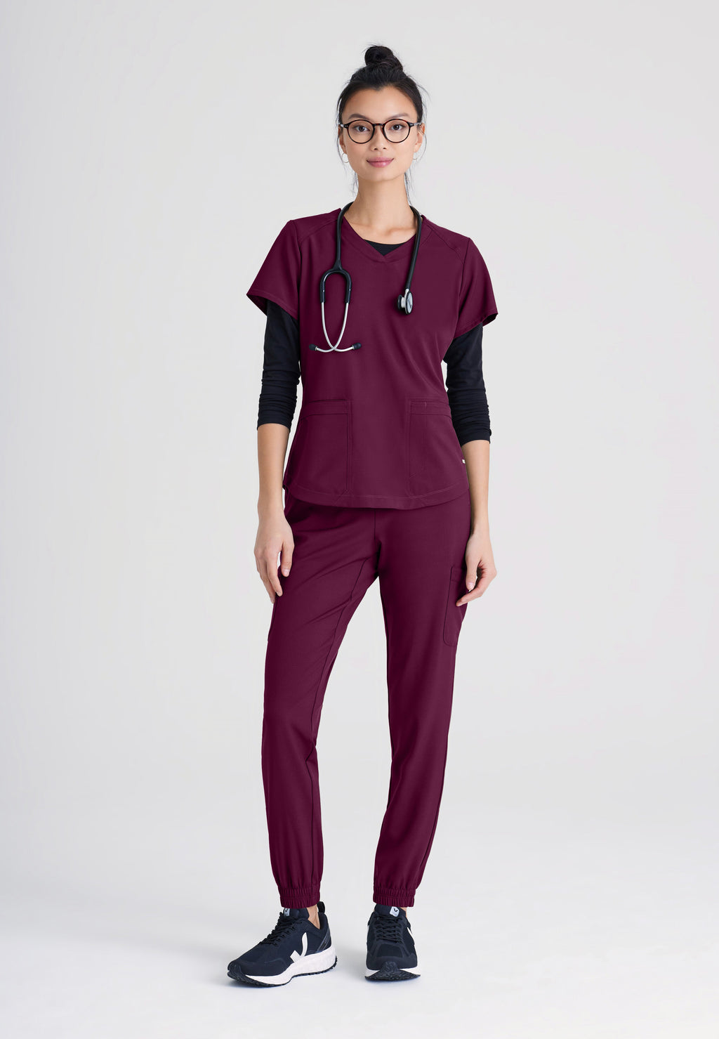 Full Body View of the Rhythm 2-Pocket Ciclo® Scrub Top in Wine from Grey's Anatomy™ by Barco Evolve