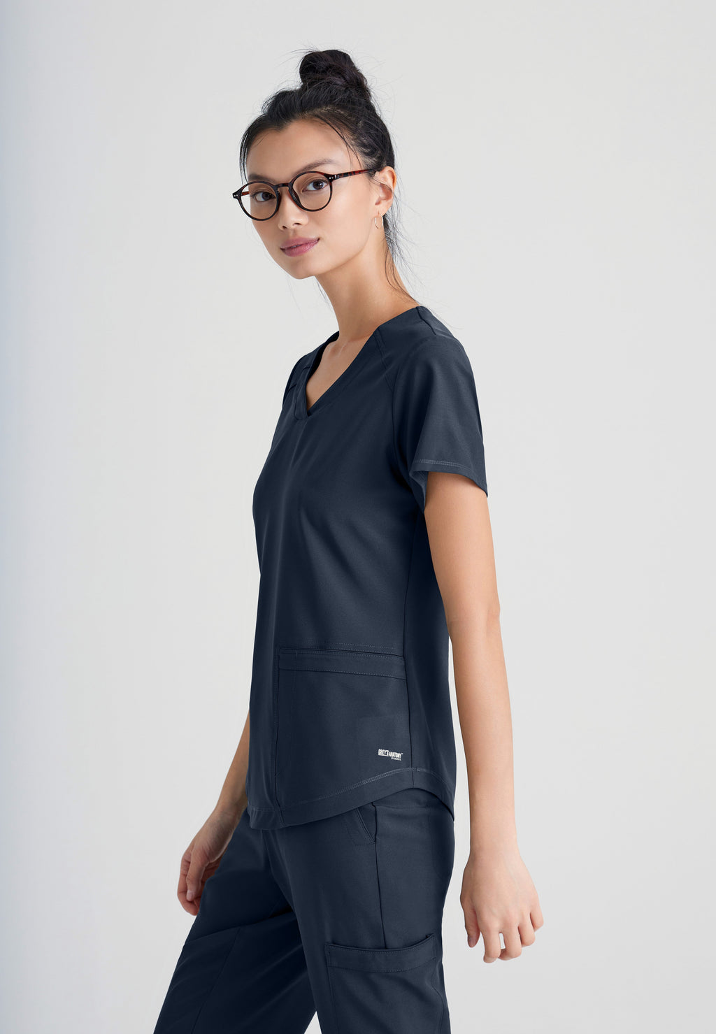 Side View of the Rhythm 2-Pocket Ciclo® Scrub Top in Steel from Grey's Anatomy™ by Barco Evolve