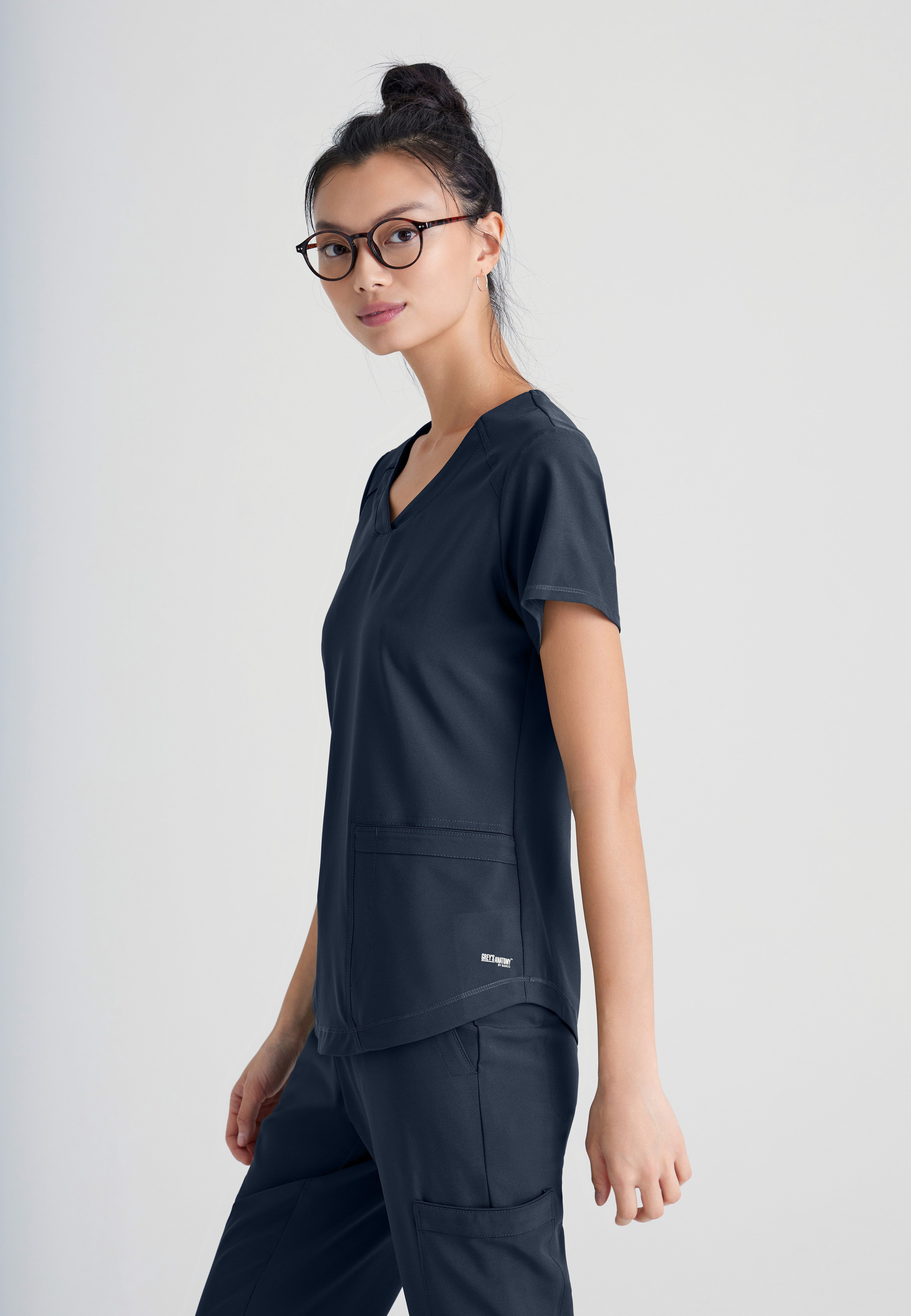 Side View of the Rhythm 2-Pocket Ciclo® Scrub Top in Steel from Grey's Anatomy™ by Barco Evolve
