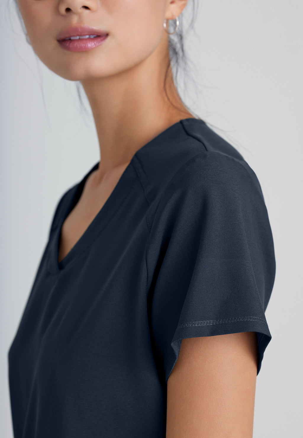 Detail Shot of the Rhythm 2-Pocket Ciclo® Scrub Top in Steel from Grey's Anatomy™ by Barco Evolve