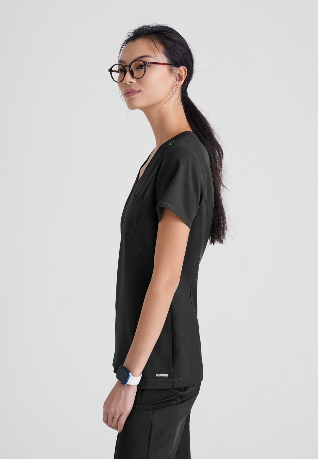 Side View of the Sway 1-Pocket Banded V-Neck Ciclo® Scrub Top in Black from Grey's Anatomy™ by Barco Evolve