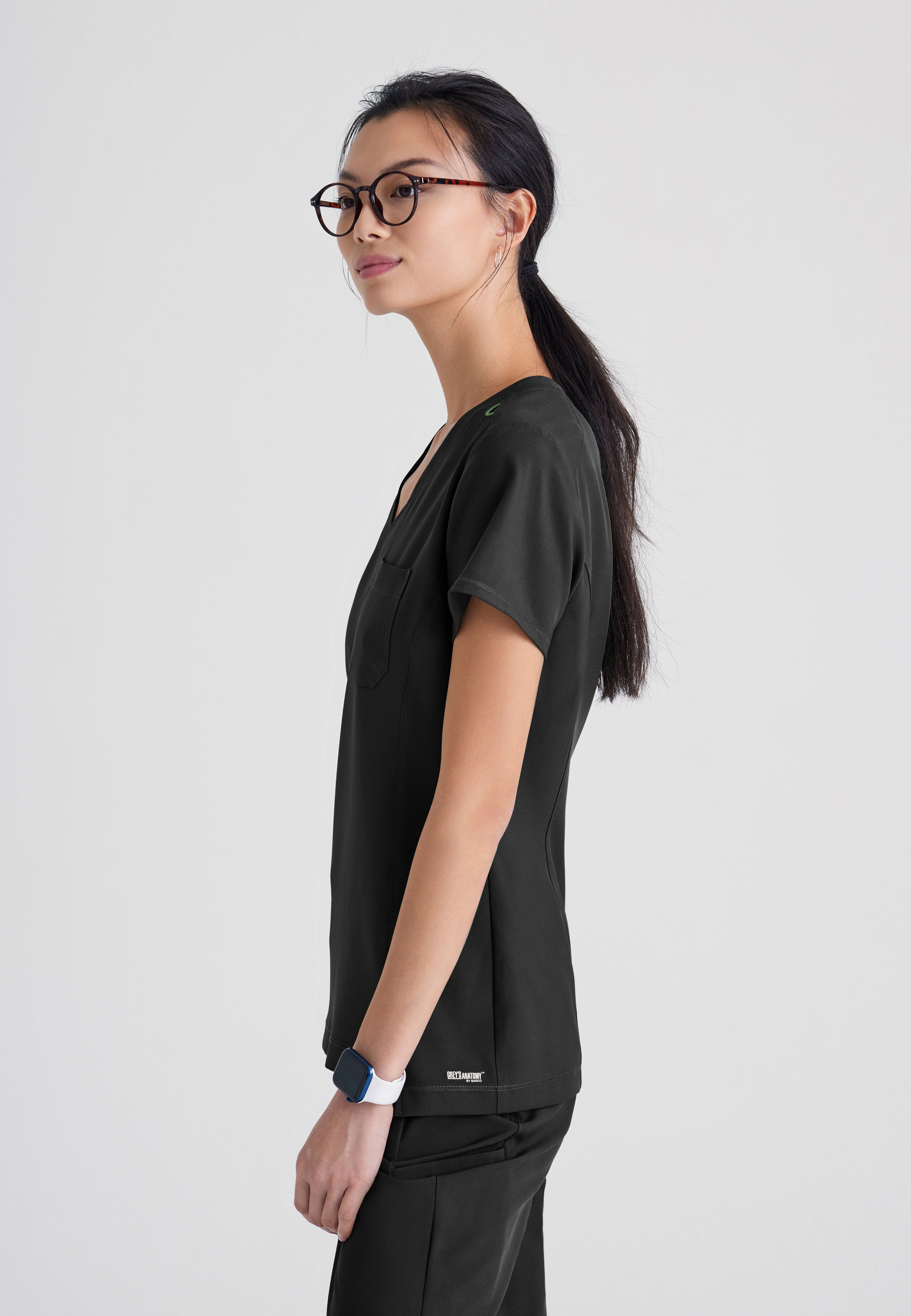 Side View of the Sway 1-Pocket Banded V-Neck Ciclo® Scrub Top in Black from Grey's Anatomy™ by Barco Evolve