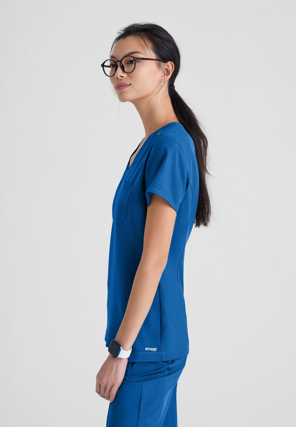 Side View of the Sway 1-Pocket Banded V-Neck Ciclo® Scrub Top in New Royal from Grey's Anatomy™ by Barco Evolve