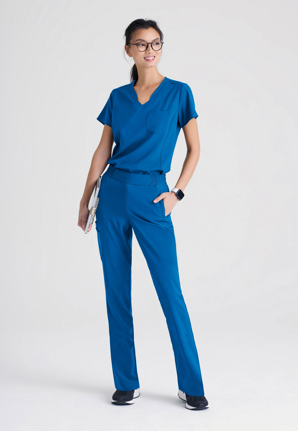 Full Body View of the Cosmo 6-Pocket Mid-Rise Tapered Leg Ciclo® Scrub Pant in New Royal from Grey's Anatomy™ by Barco Evolve