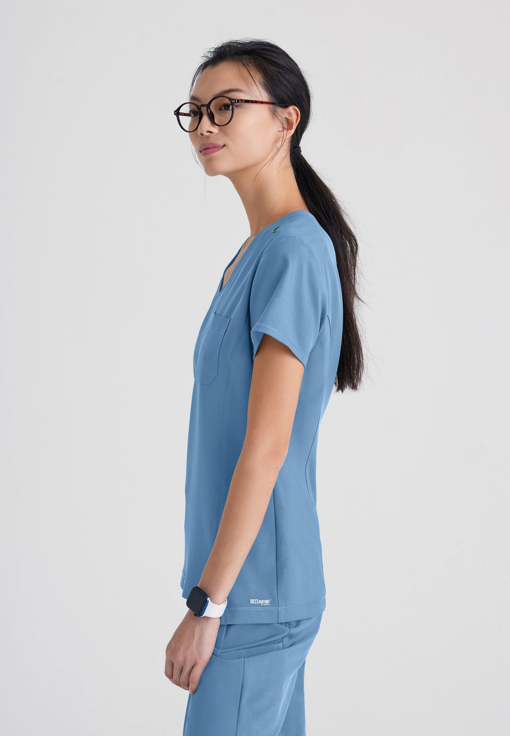 Side View of the Sway 1-Pocket Banded V-Neck Ciclo® Scrub Top in Ciel Blue from Grey's Anatomy™ by Barco Evolve