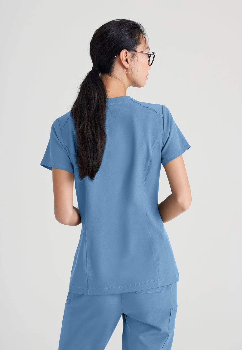 Back View of the Sway 1-Pocket Banded V-Neck Ciclo® Scrub Top in Ciel Blue from Grey's Anatomy™ by Barco Evolve