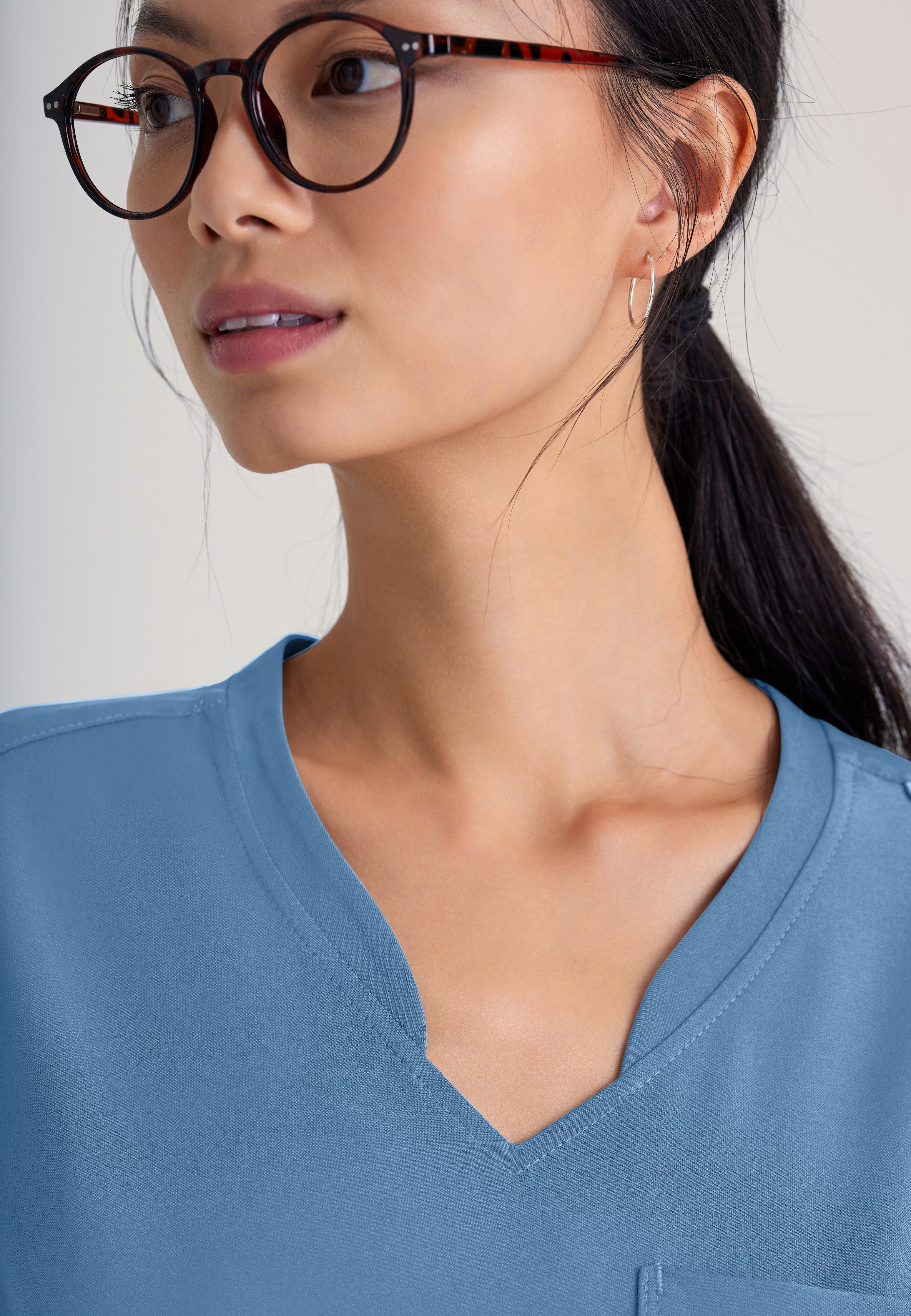 Detail Shot of the Sway 1-Pocket Banded V-Neck Ciclo® Scrub Top in Ciel Blue from Grey's Anatomy™ by Barco Evolve