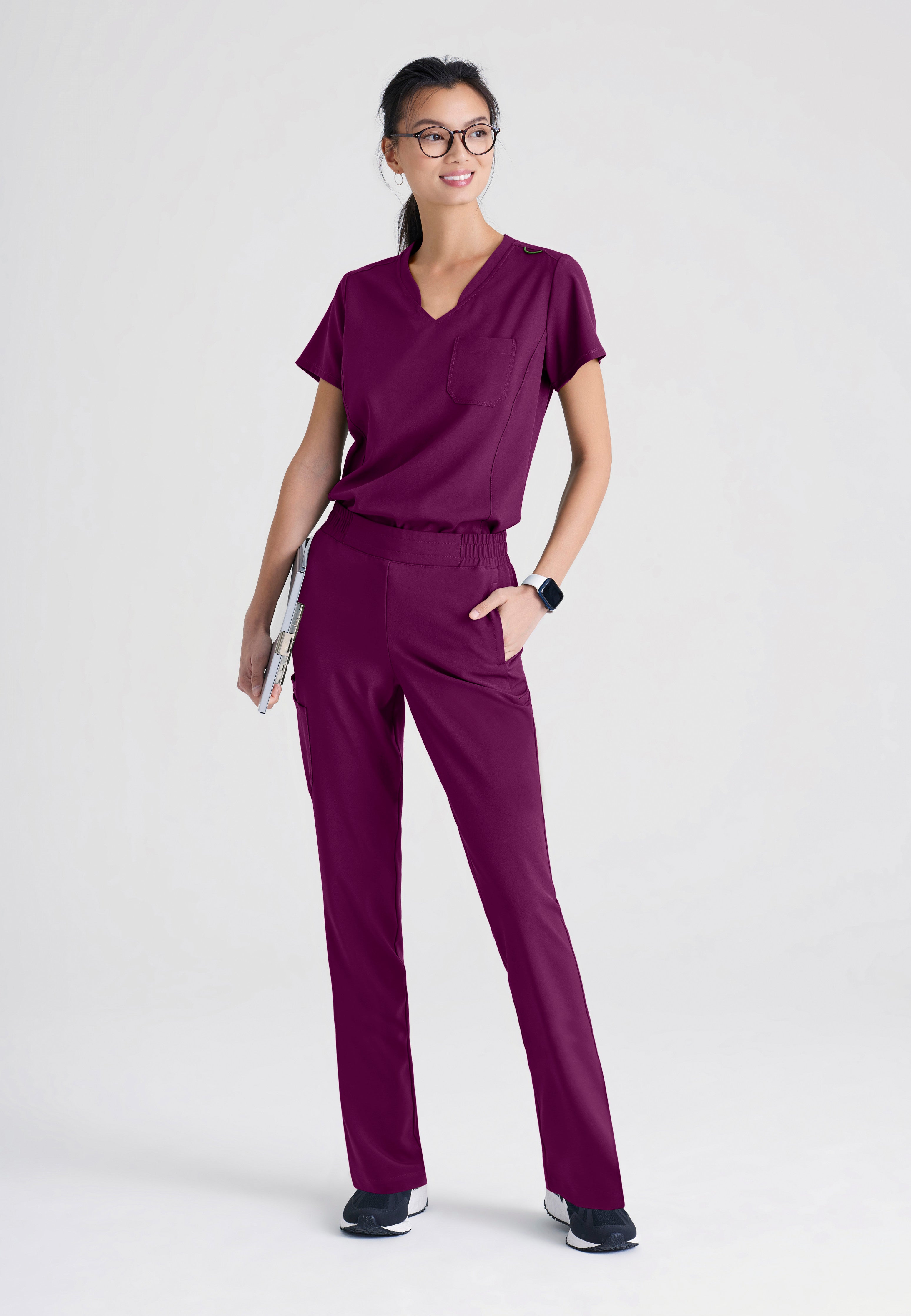 Full Body View of the Sway 1-Pocket Banded V-Neck Ciclo® Scrub Top in Wine from Grey's Anatomy™ by Barco Evolve