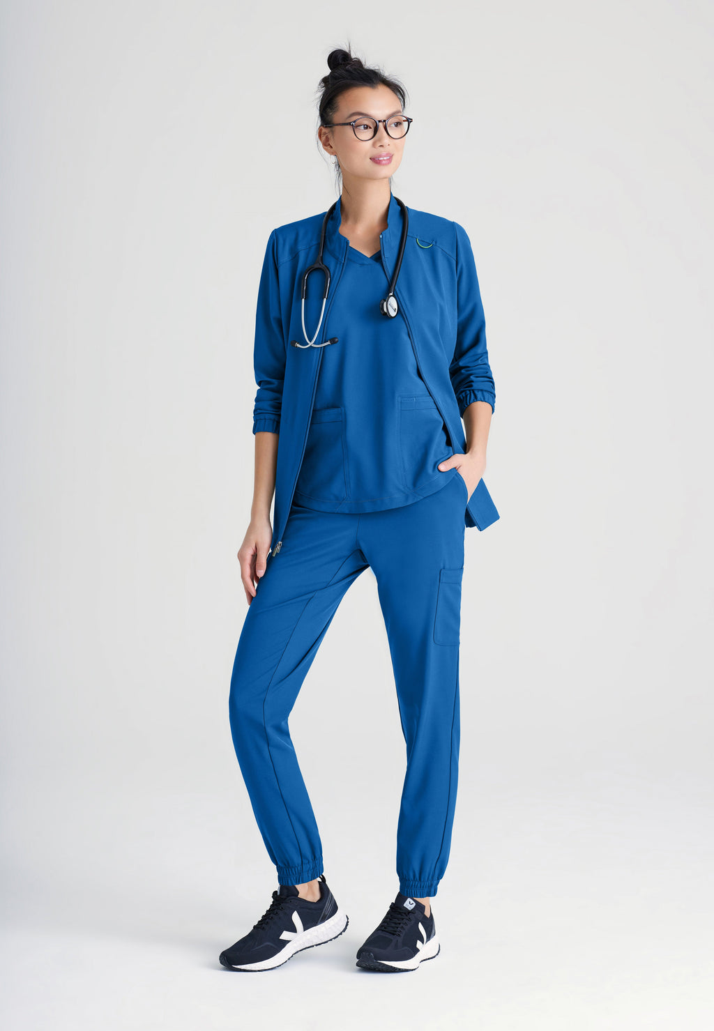 Full Body View of the Virtue 3-Pocket Stand-Up Collar Ciclo® Scrub Jacket in New Royal from Grey's Anatomy™ by Barco Evolve