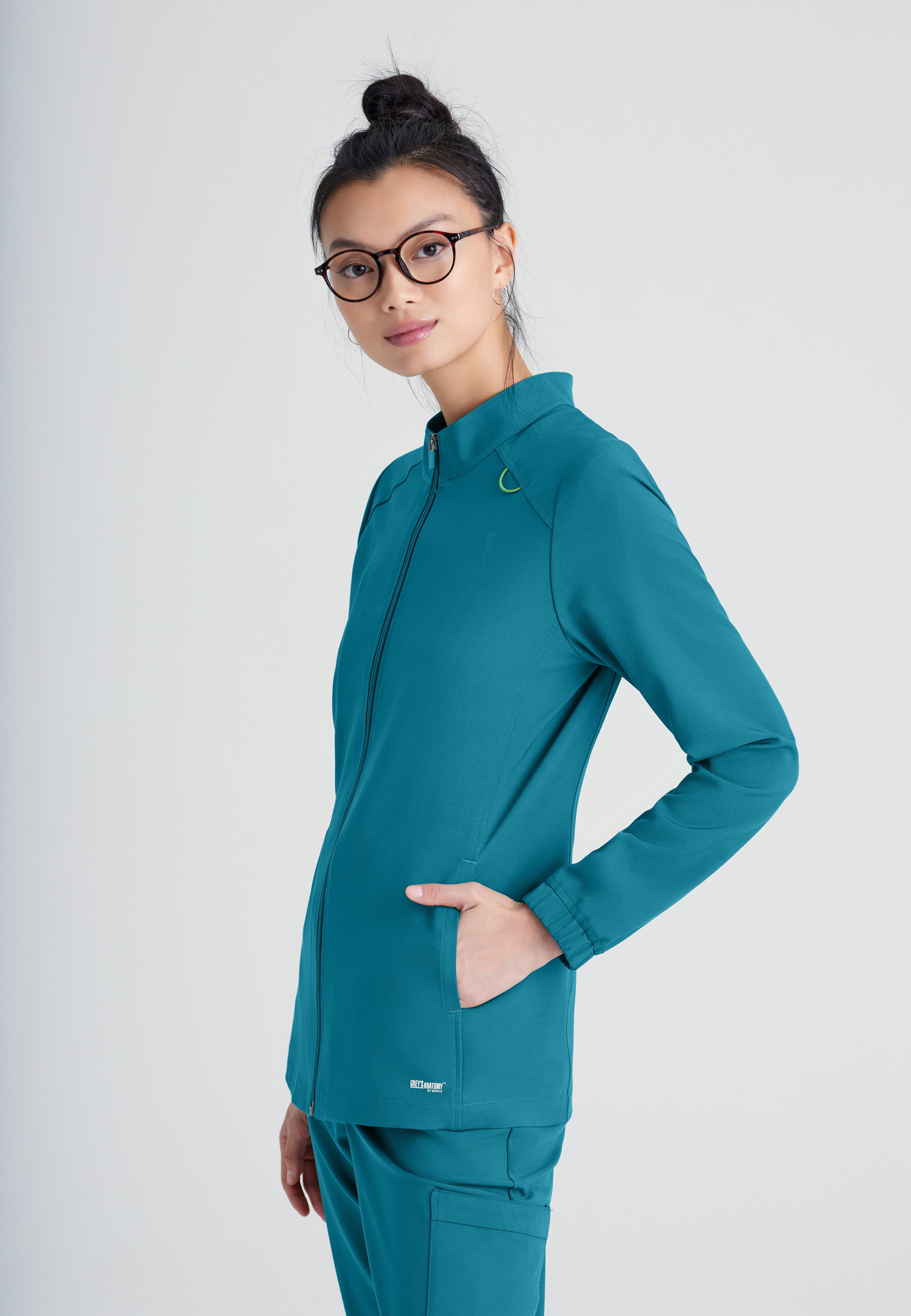 Side View of the Virtue 3-Pocket Stand-Up Collar Ciclo® Scrub Jacket in Bahama from Grey's Anatomy™ by Barco Evolve