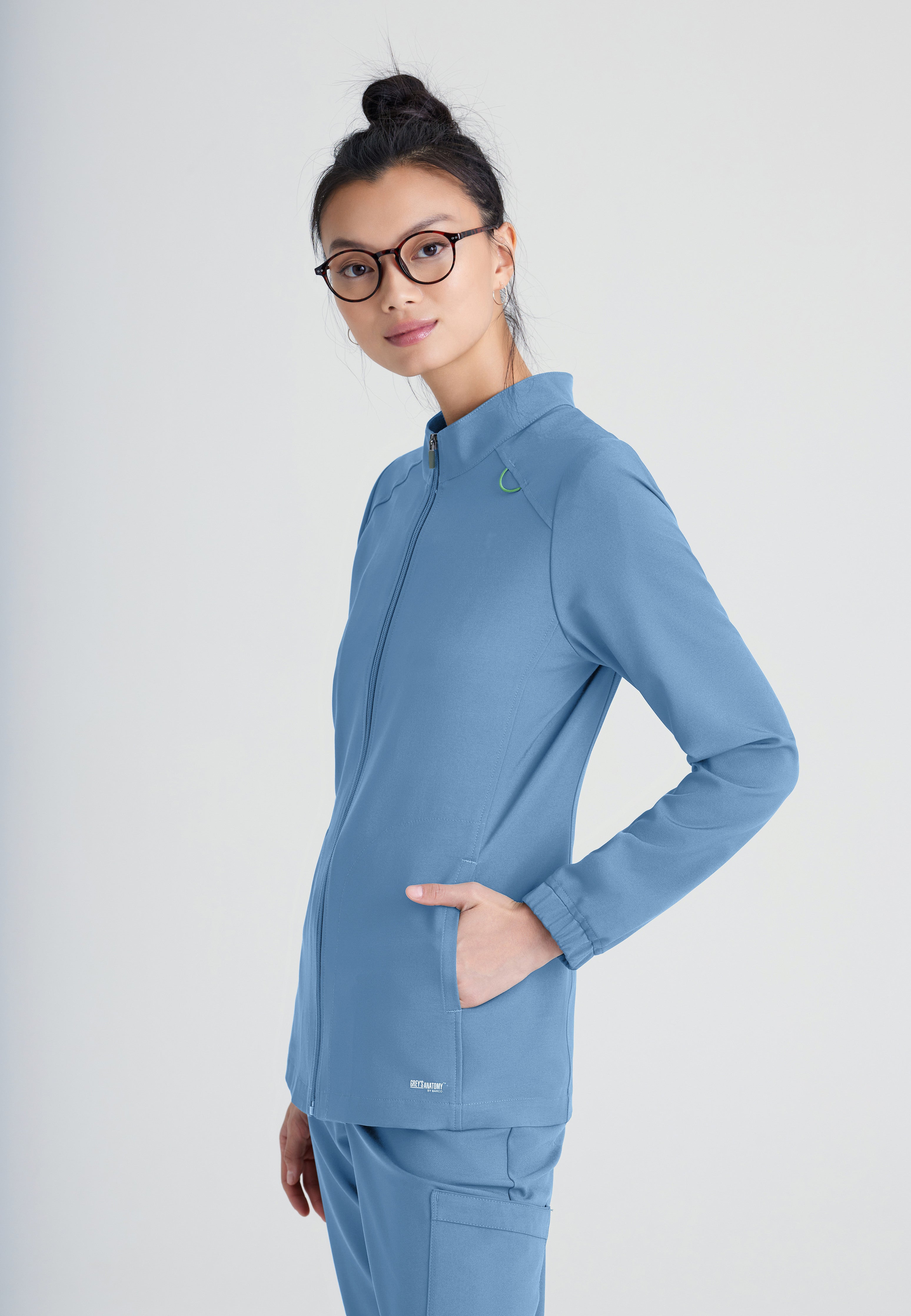 Side View of the Virtue 3-Pocket Stand-Up Collar Ciclo® Scrub Jacket in Ciel Blue from Grey's Anatomy™ by Barco Evolve
