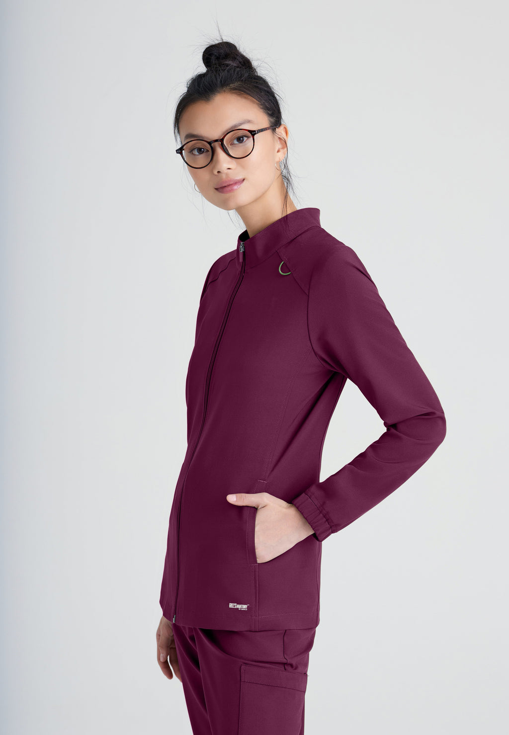 Side View of the Virtue 3-Pocket Stand-Up Collar Ciclo® Scrub Jacket in Wine from Grey's Anatomy™ by Barco Evolve