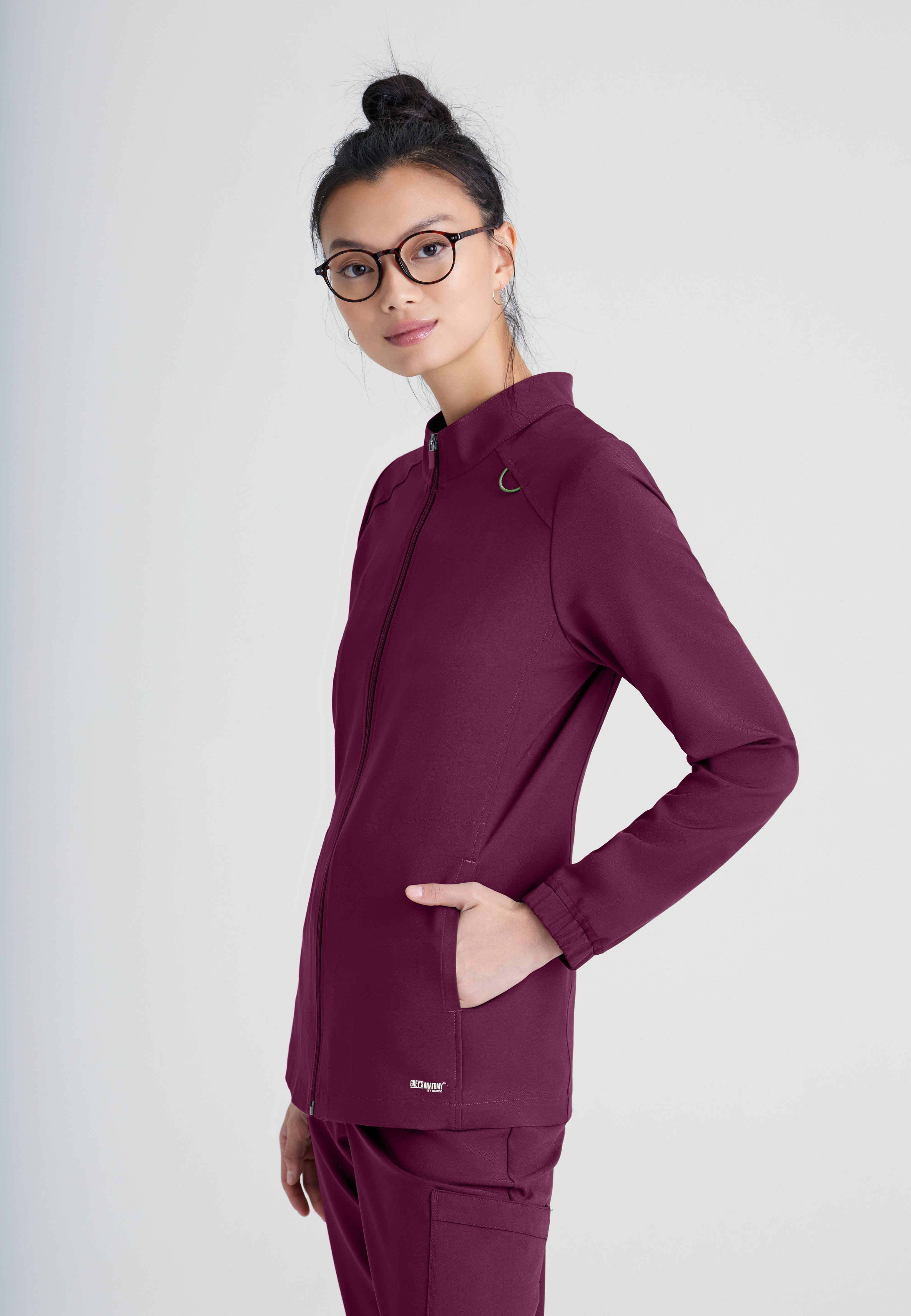Side View of the Virtue 3-Pocket Stand-Up Collar Ciclo® Scrub Jacket in Wine from Grey's Anatomy™ by Barco Evolve