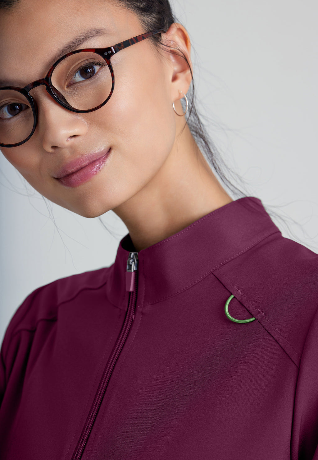 Detail Shot of the Virtue 3-Pocket Stand-Up Collar Ciclo® Scrub Jacket in Wine from Grey's Anatomy™ by Barco Evolve