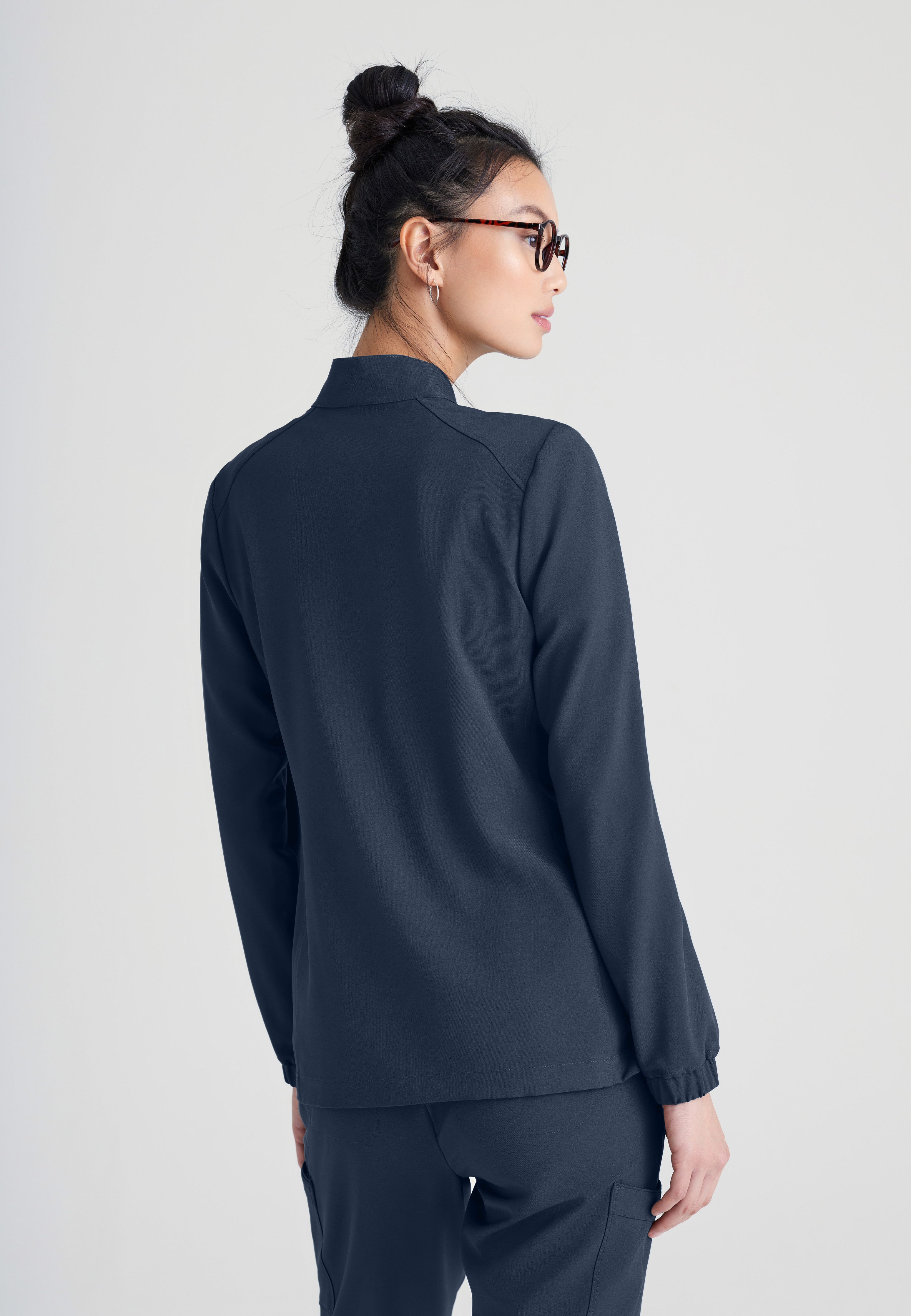 Back View of the Virtue 3-Pocket Stand-Up Collar Ciclo® Scrub Jacket in Steel from Grey's Anatomy™ by Barco Evolve