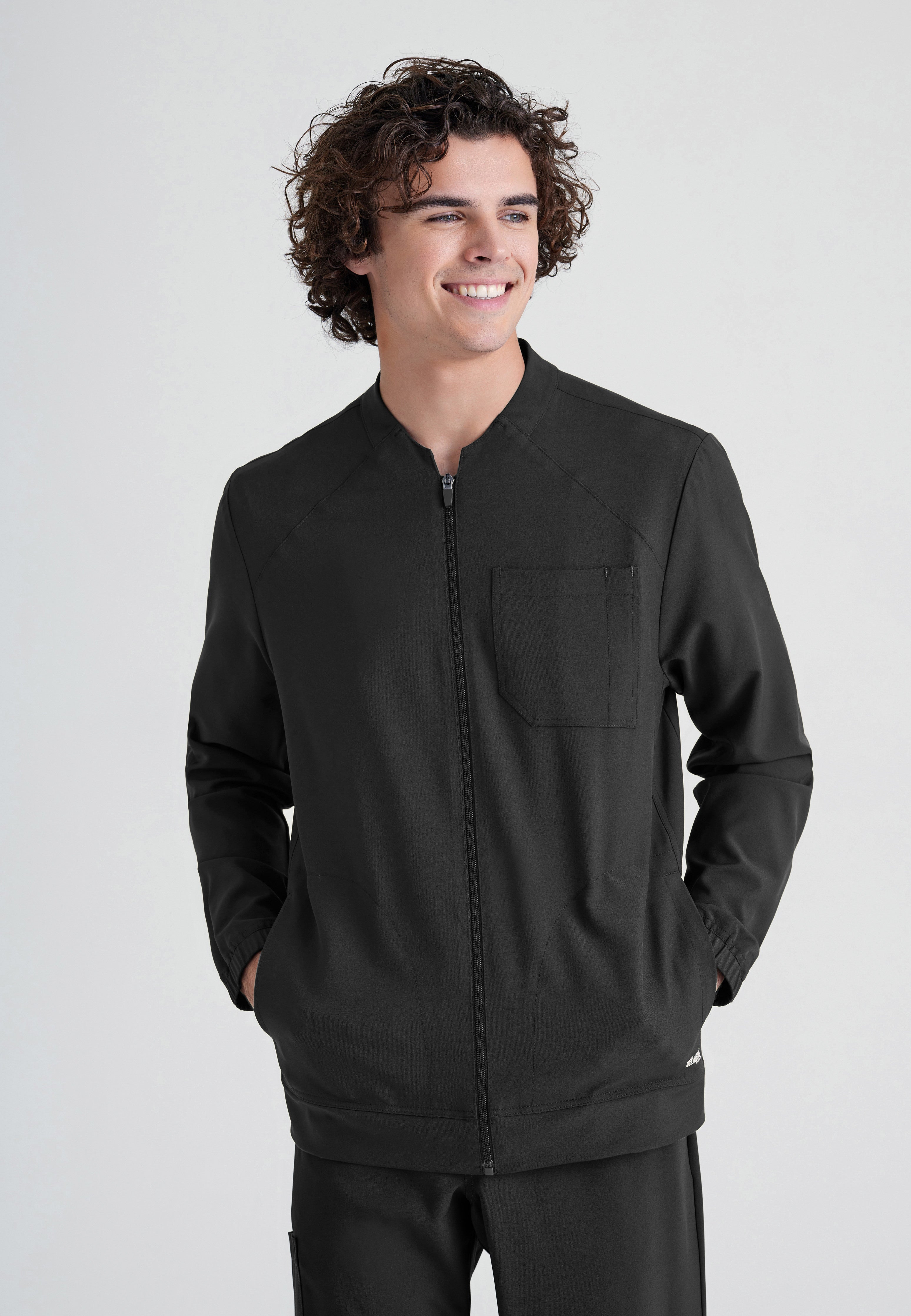 Front View of the Cycle 3-Pocket Crewneck Ciclo® Scrub Jacket in Black from Grey's Anatomy™ by Barco Evolve