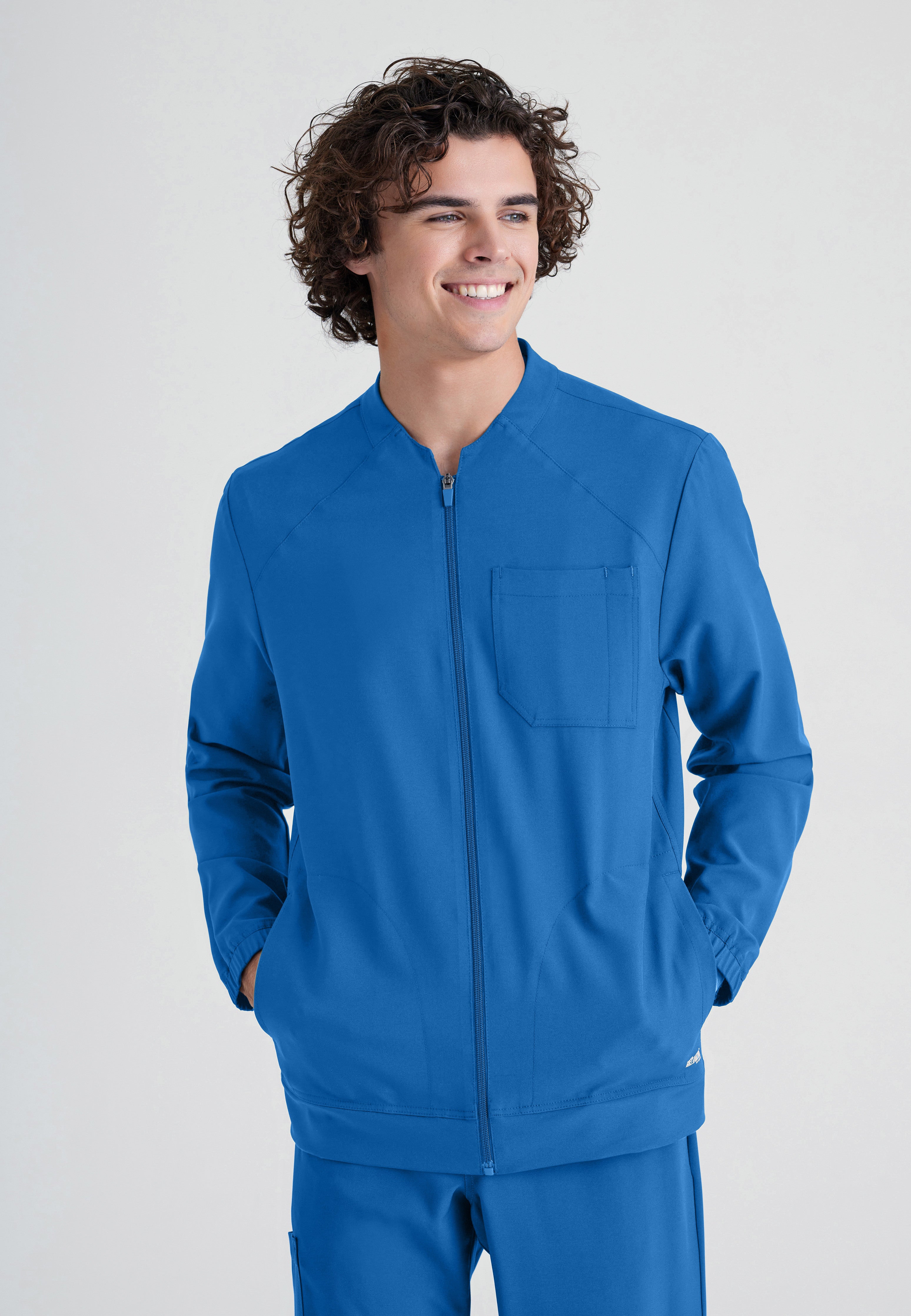 Front View of the Cycle 3-Pocket Crewneck Ciclo® Scrub Jacket in New Royal from Grey's Anatomy™ by Barco Evolve