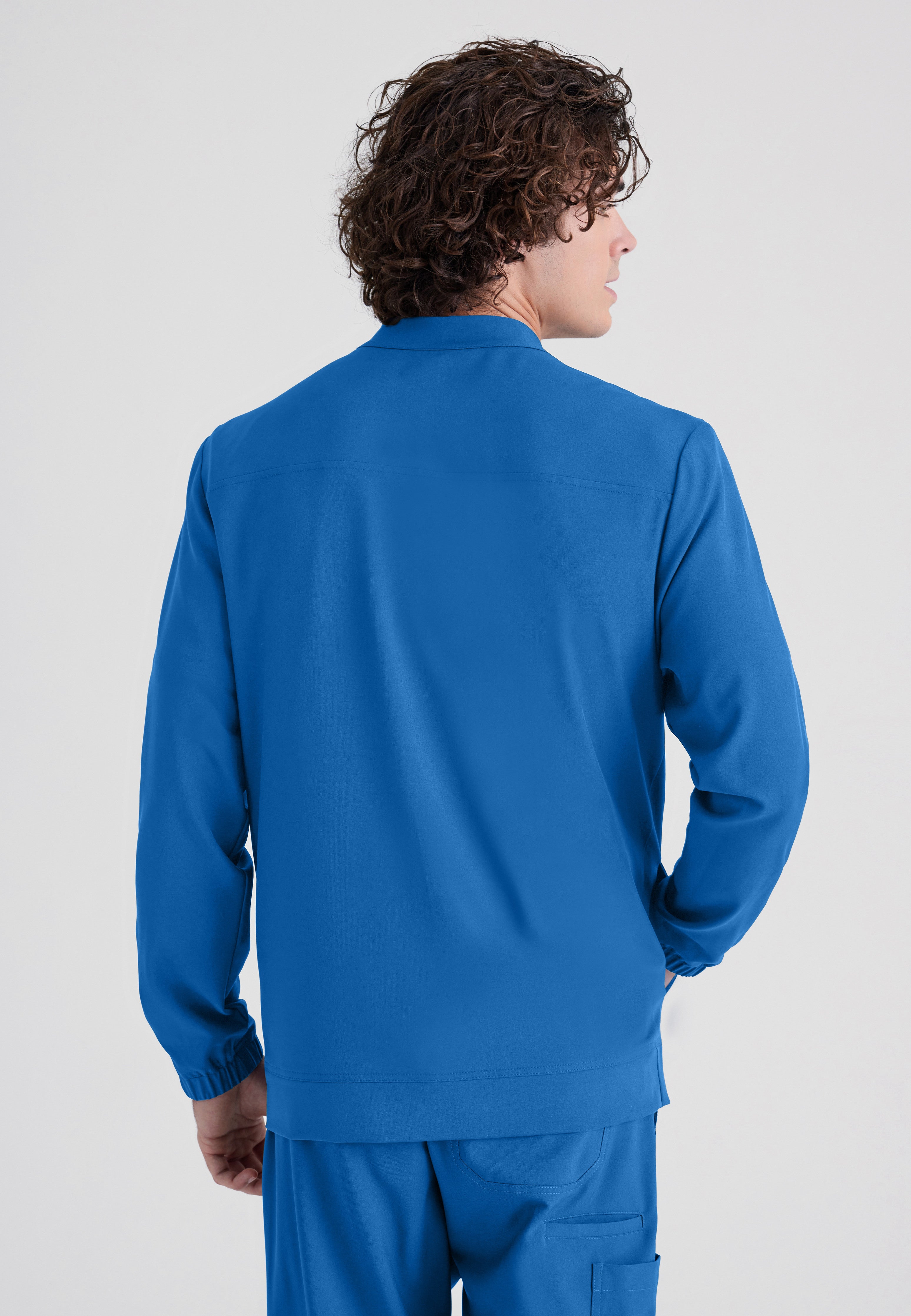 Back View of the Cycle 3-Pocket Crewneck Ciclo® Scrub Jacket in New Royal from Grey's Anatomy™ by Barco Evolve