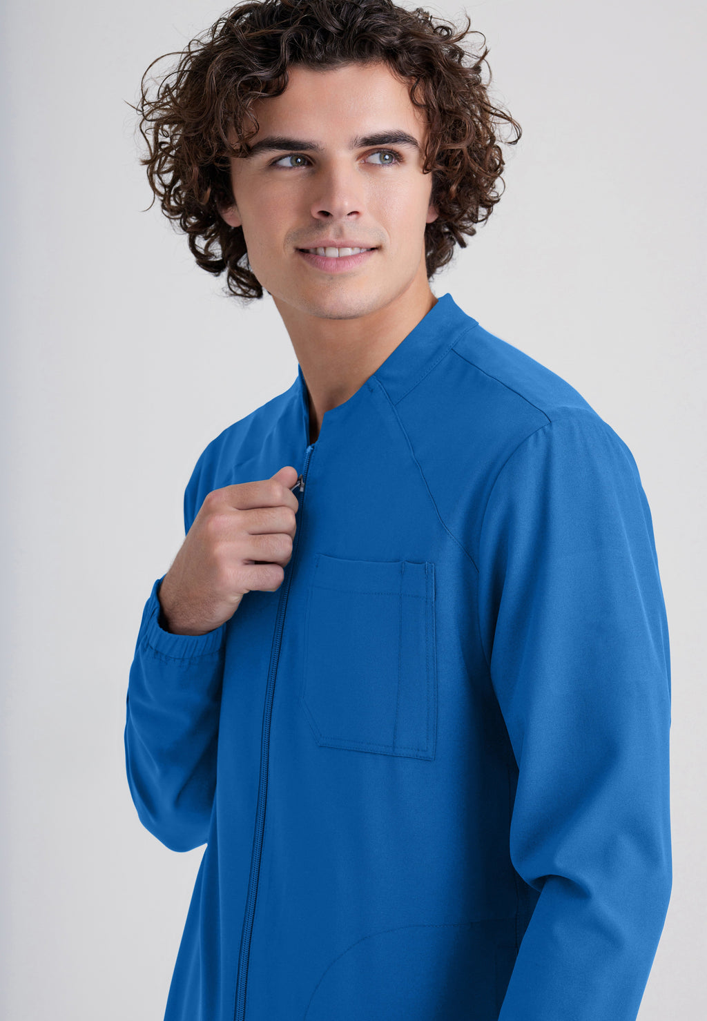 Detail Shot of the Cycle 3-Pocket Crewneck Ciclo® Scrub Jacket in New Royal from Grey's Anatomy™ by Barco Evolve