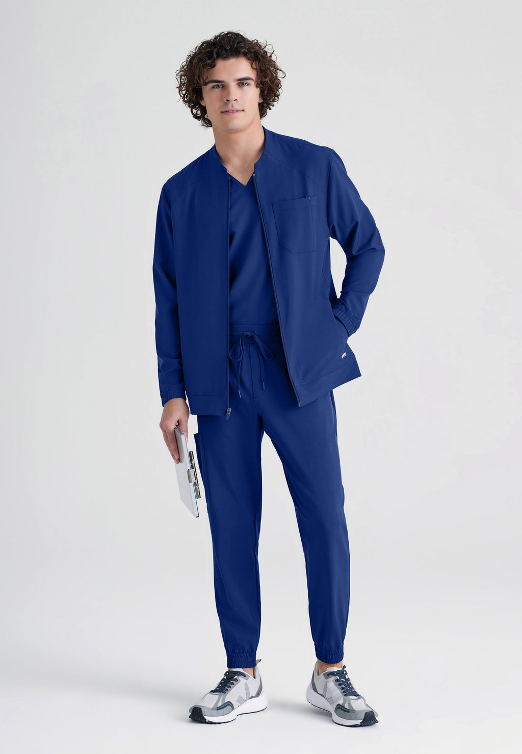 Full Body View of the Cycle 3-Pocket Crewneck Ciclo® Scrub Jacket in Indigo from Grey's Anatomy™ by Barco Evolve