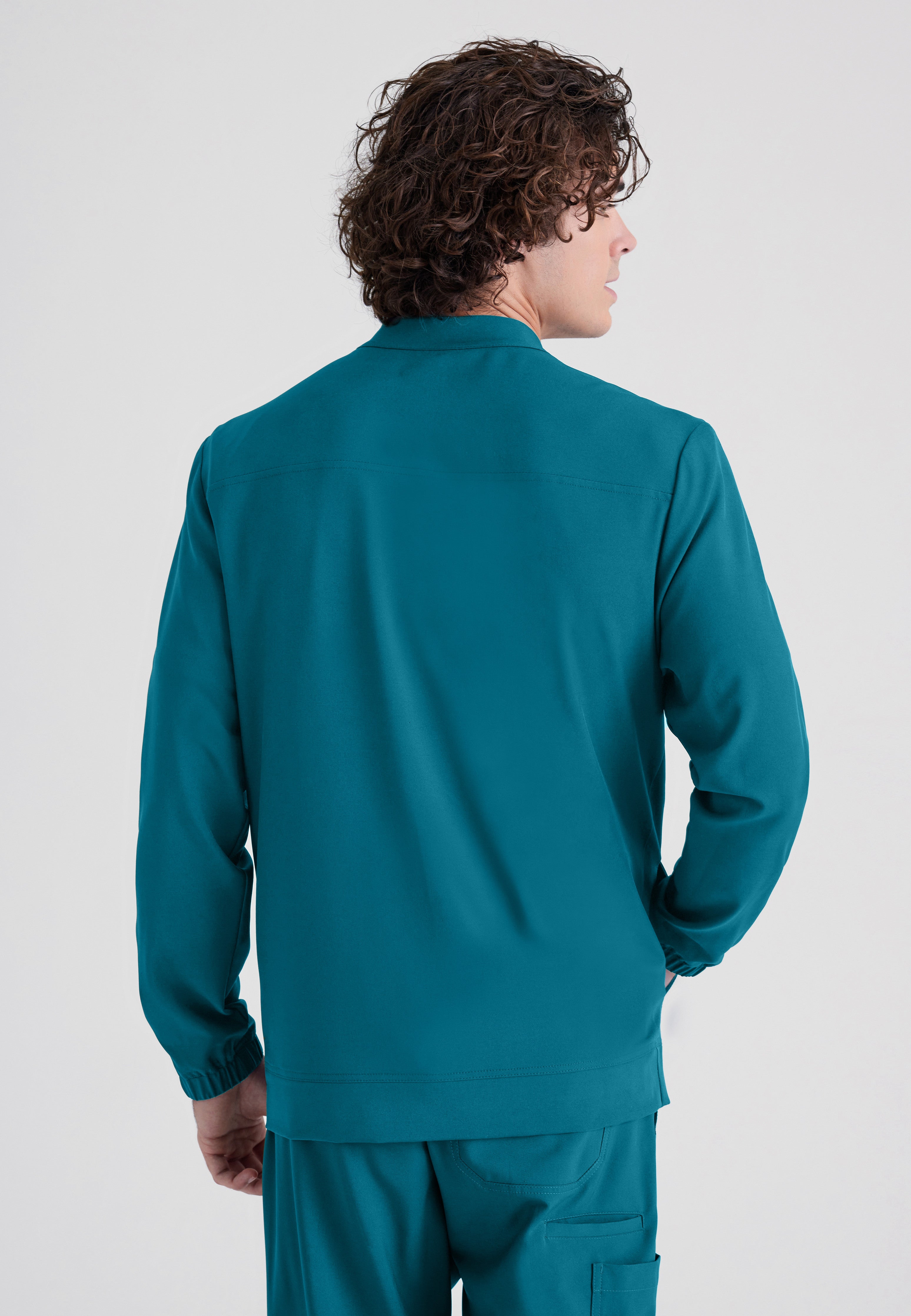Back View of the Cycle 3-Pocket Crewneck Ciclo® Scrub Jacket in Bahama from Grey's Anatomy™ by Barco Evolve