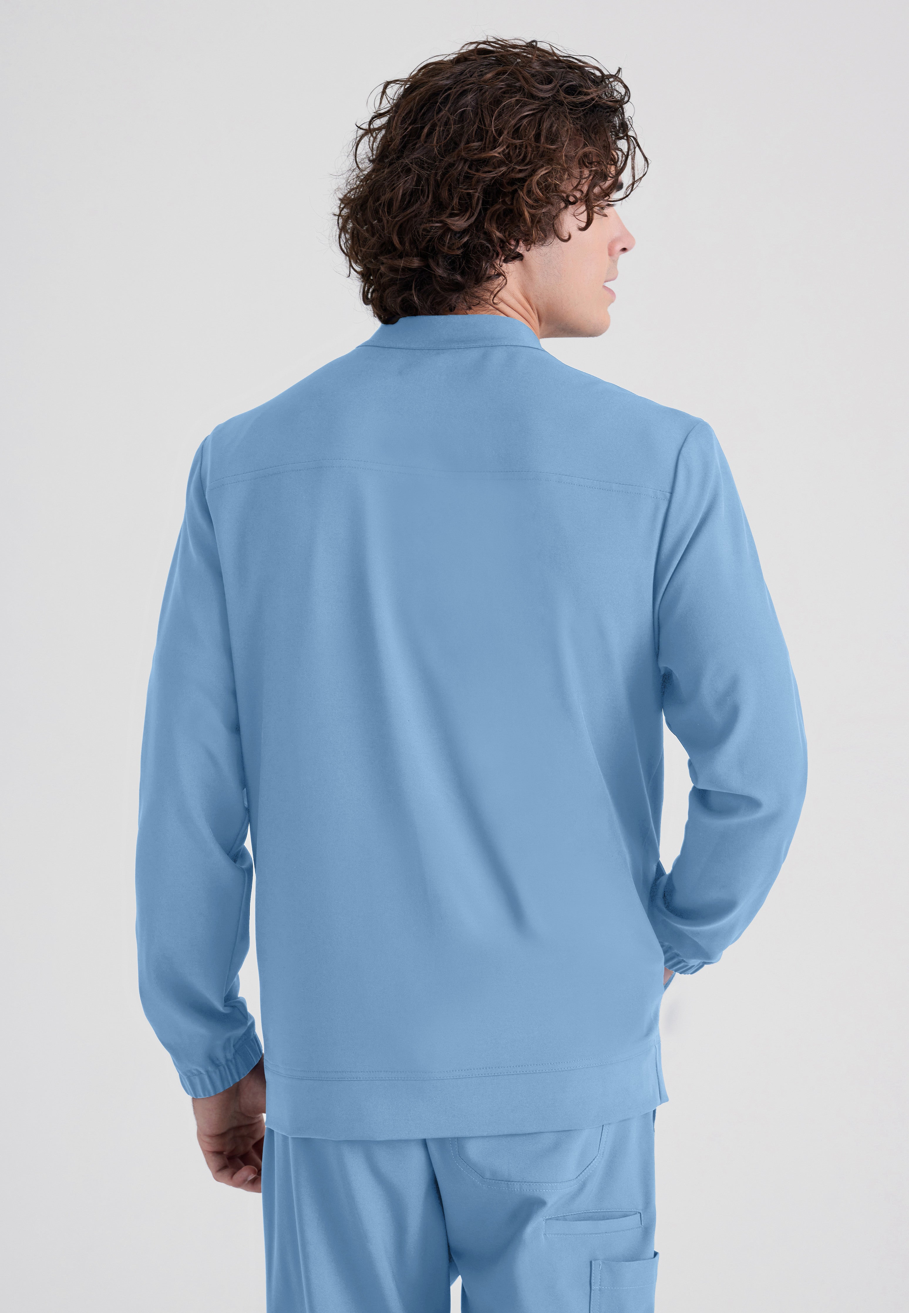 Back View of the Cycle 3-Pocket Crewneck Ciclo® Scrub Jacket in Ciel Blue from Grey's Anatomy™ by Barco Evolve