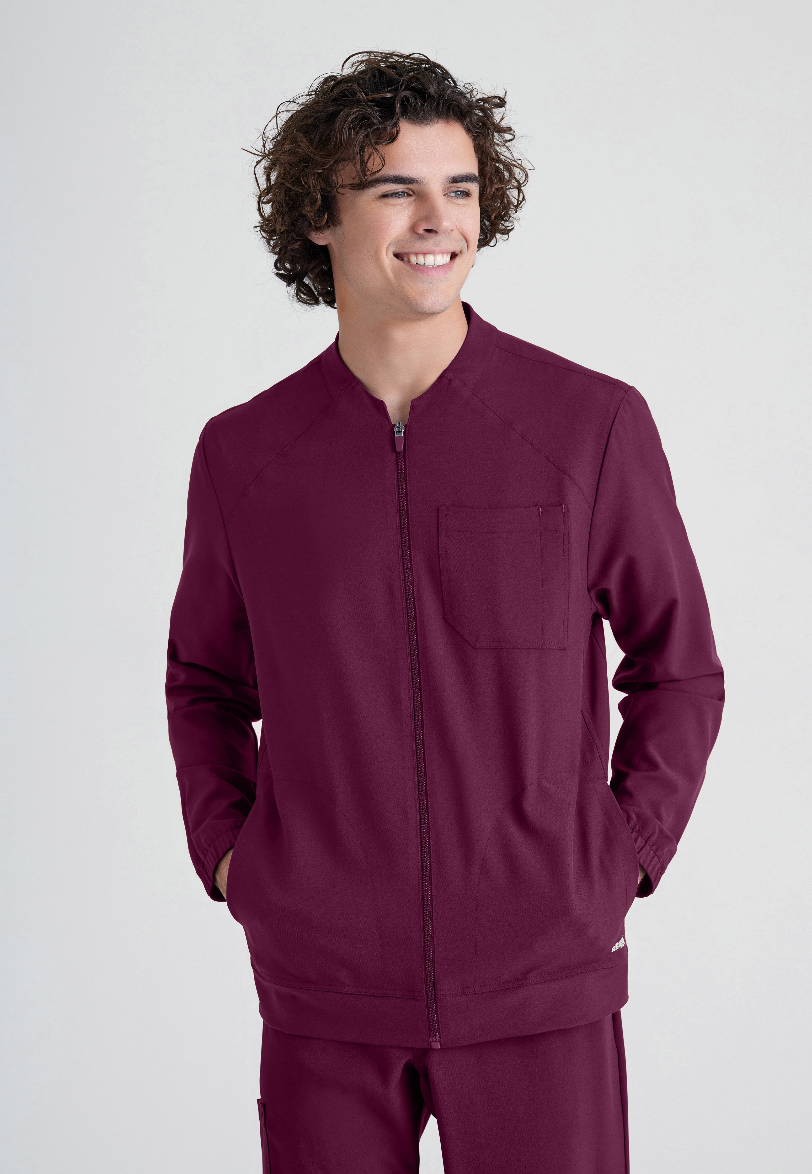Front View of the Cycle 3-Pocket Crewneck Ciclo® Scrub Jacket in Wine from Grey's Anatomy™ by Barco Evolve