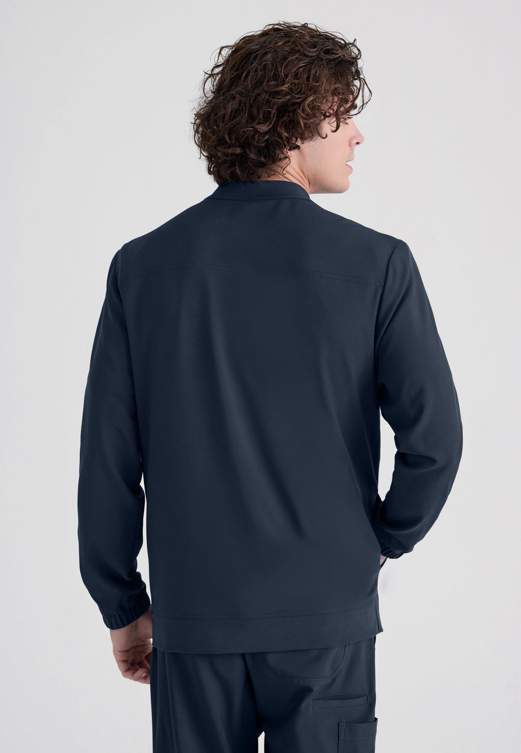 Back View of the Cycle 3-Pocket Crewneck Ciclo® Scrub Jacket in Steel from Grey's Anatomy™ by Barco Evolve