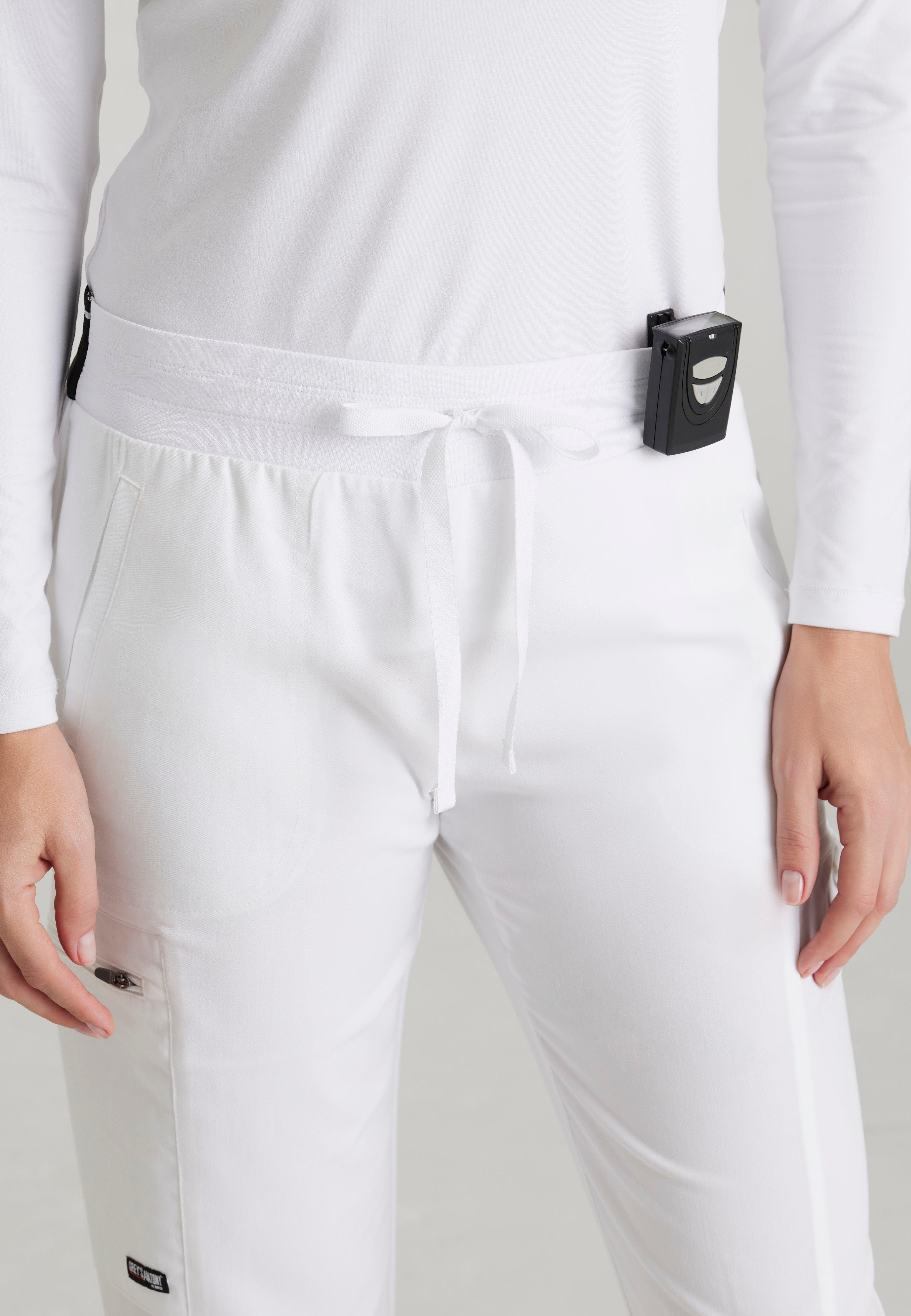 Detail Shot of the Kim 3-Pocket Mid-Rise Straight Leg Scrub Pant in White from Grey's Anatomy™ by Barco Spandex Stretch