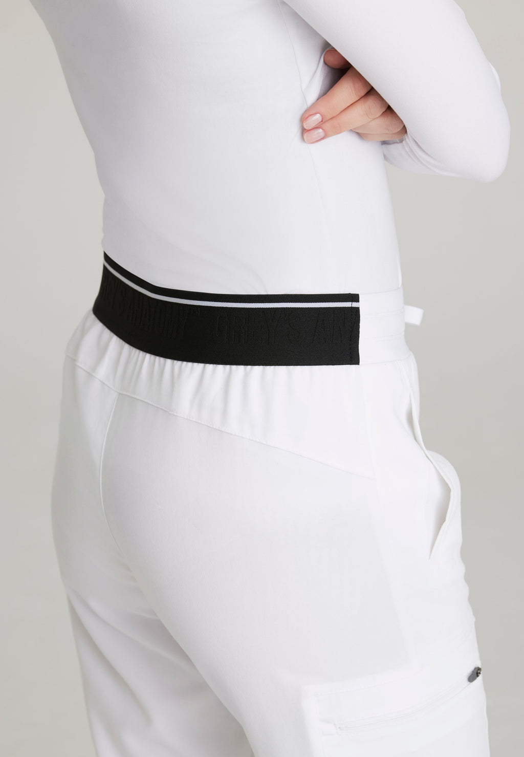 Detail Shot of the Kim 3-Pocket Mid-Rise Straight Leg Scrub Pant in White from Grey's Anatomy™ by Barco Spandex Stretch