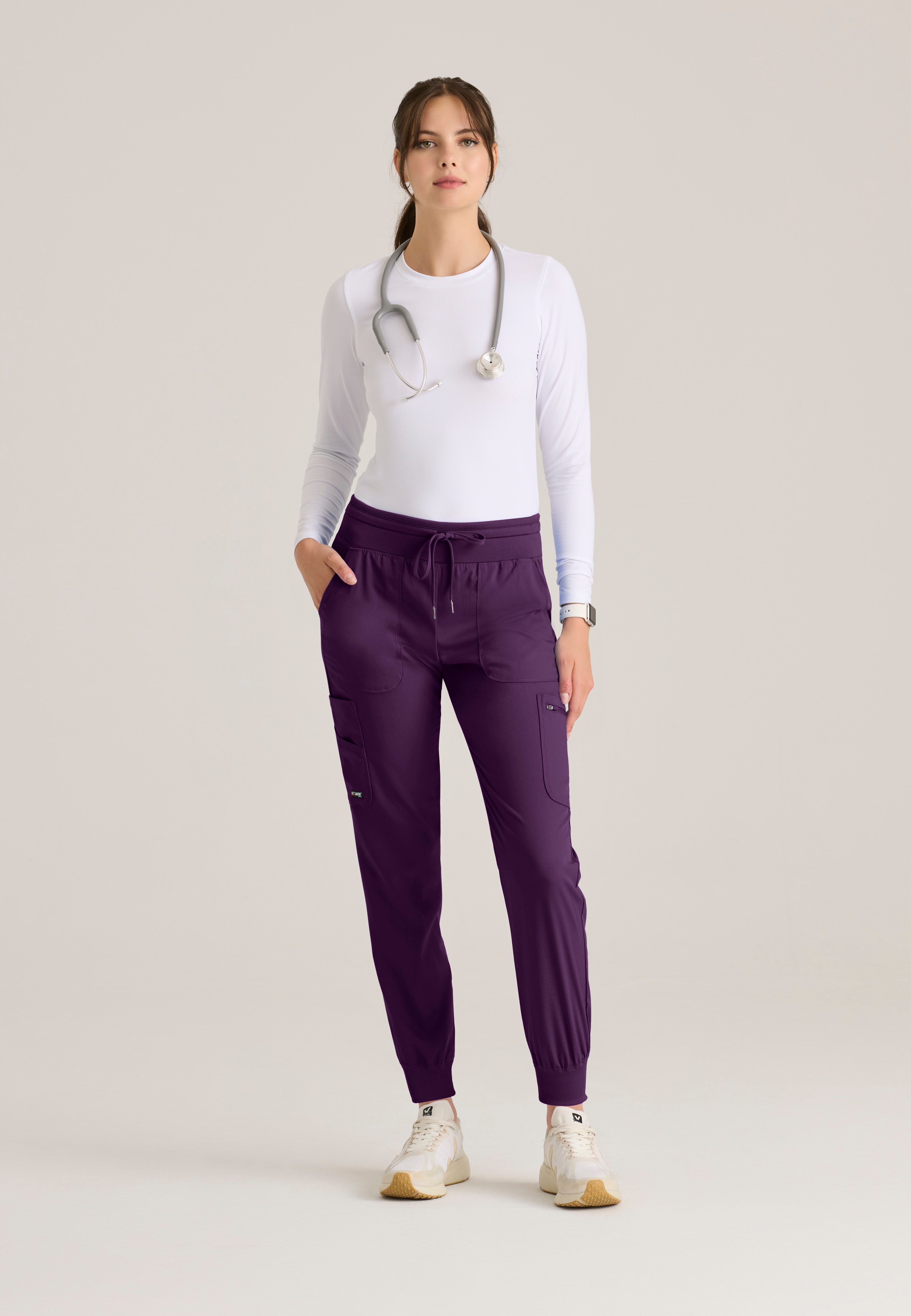 Full Body View of the Carly Jogger Scrub Pant in Eggplant from Grey's Anatomy™ by Barco Spandex Stretch