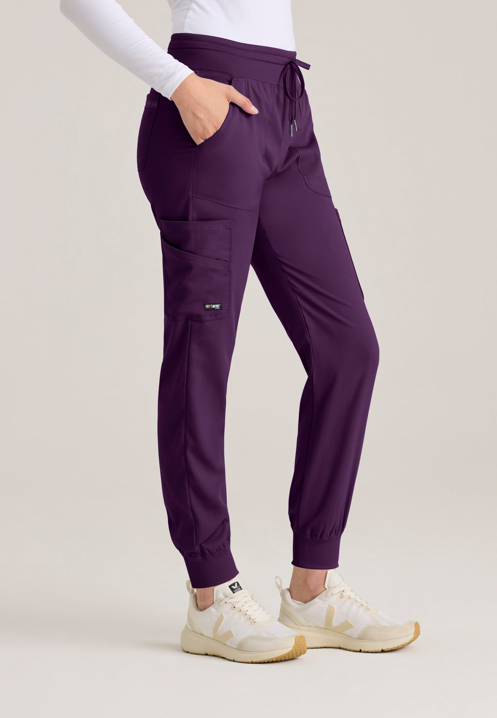 Side View of the Carly Jogger Scrub Pant in Eggplant from Grey's Anatomy™ by Barco Spandex Stretch