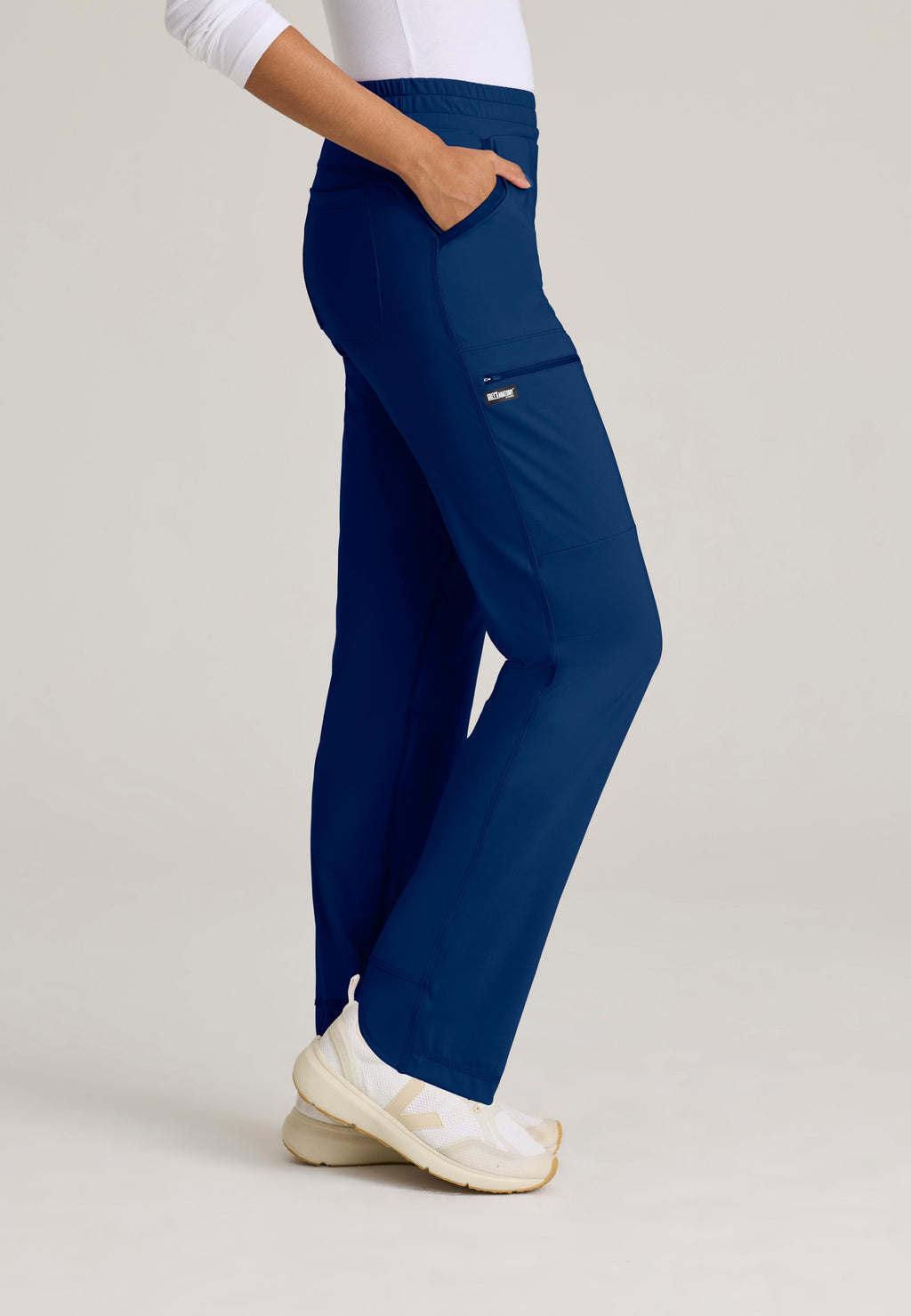 Side View of the Momentum Straight Leg Knit Pant in Indigo from Grey's Anatomy™ by Barco Knit Stretch