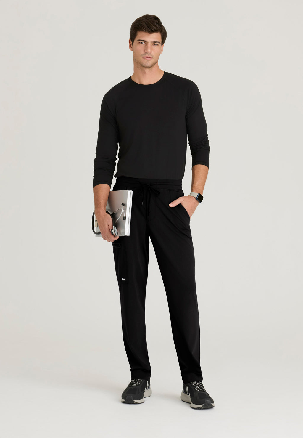 Full Body View of the Focus 4-Pocket Slim Straight Knit Pant in Black from Grey's Anatomy™ by Barco Knit Stretch