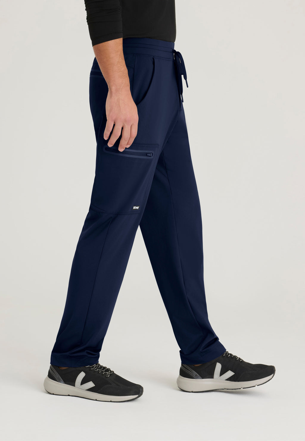 Side View of the Focus 4-Pocket Slim Straight Knit Pant in Indigo from Grey's Anatomy™ by Barco Knit Stretch