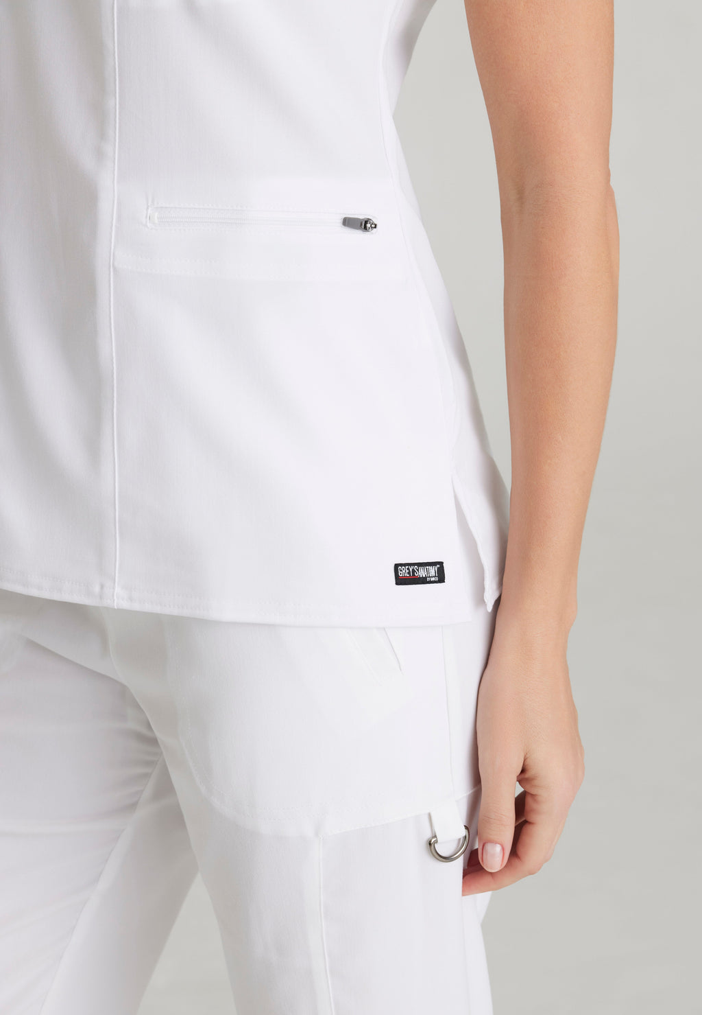 Detail Shot of the Kim 3-Pocket Crossover V-Neck Scrub Top in White from Grey's Anatomy™ by Barco Spandex Stretch