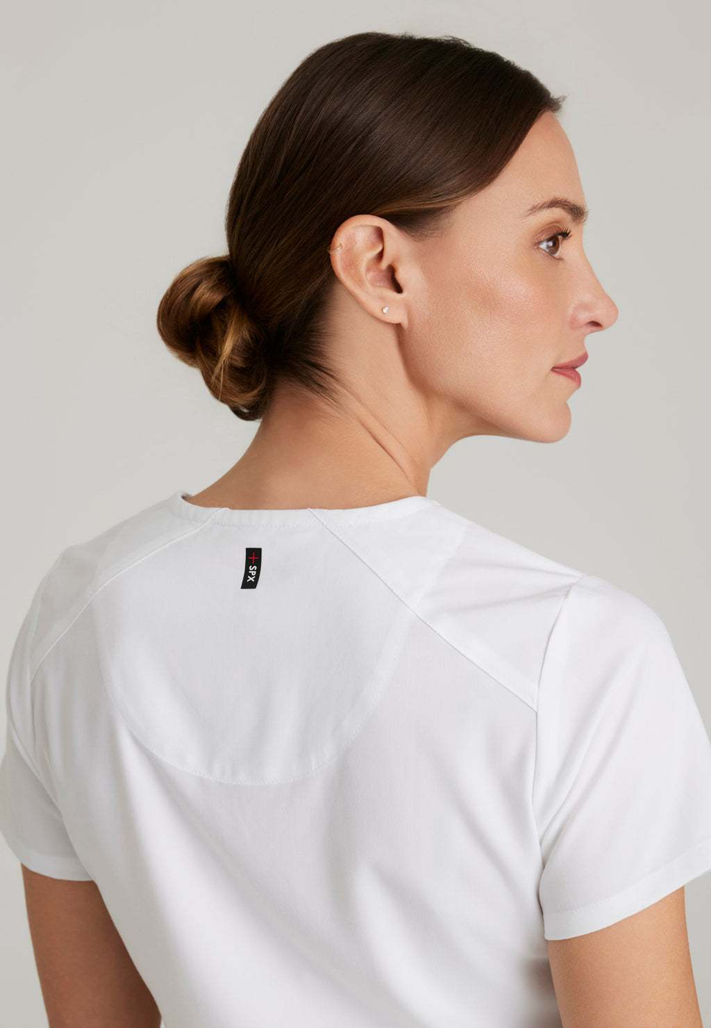 Detail Shot of the Emma 4-Pocket V-Neck Scrub Top in White from Grey's Anatomy™ by Barco Spandex Stretch