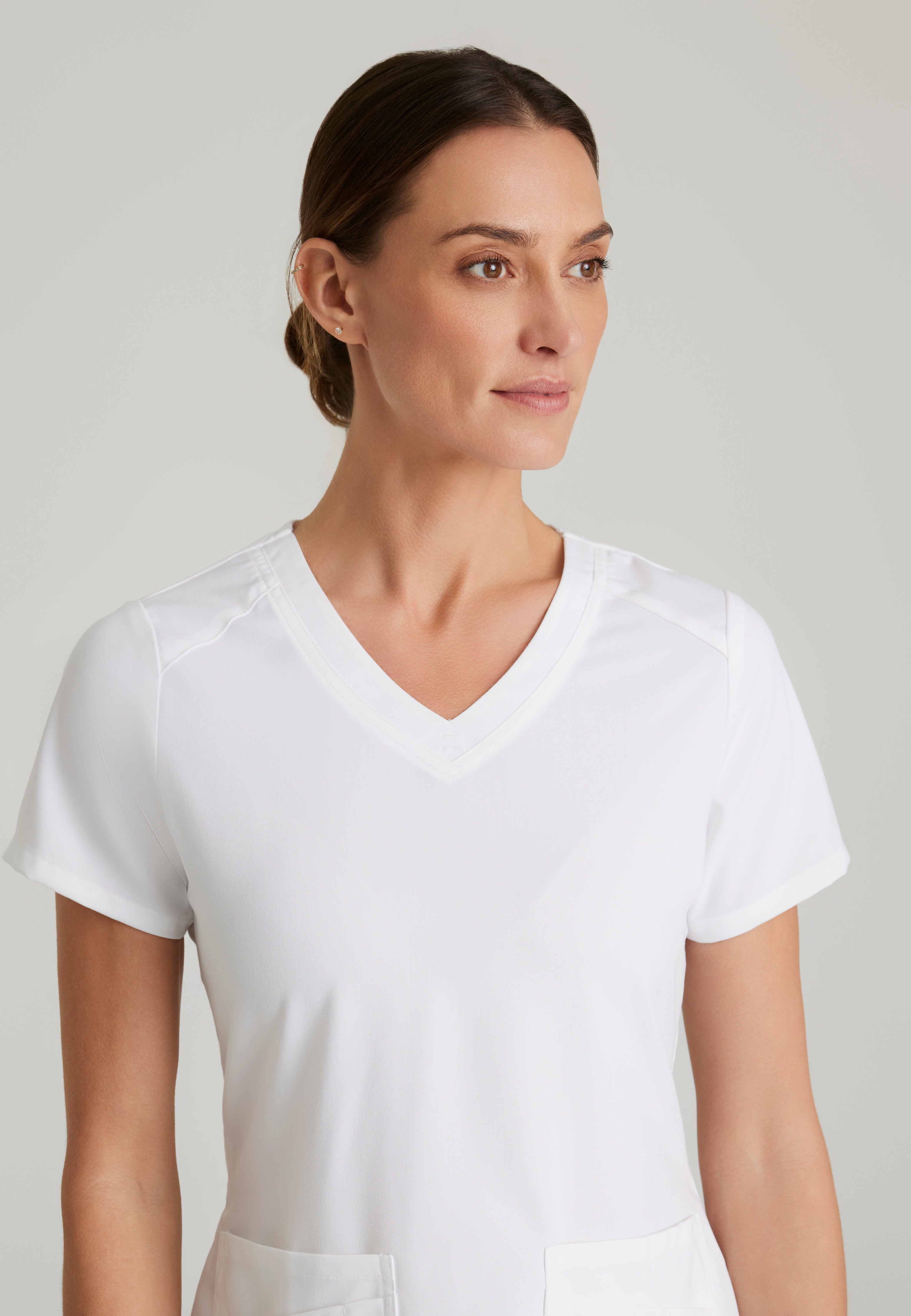 Detail Shot of the Emma 4-Pocket V-Neck Scrub Top in White from Grey's Anatomy™ by Barco Spandex Stretch