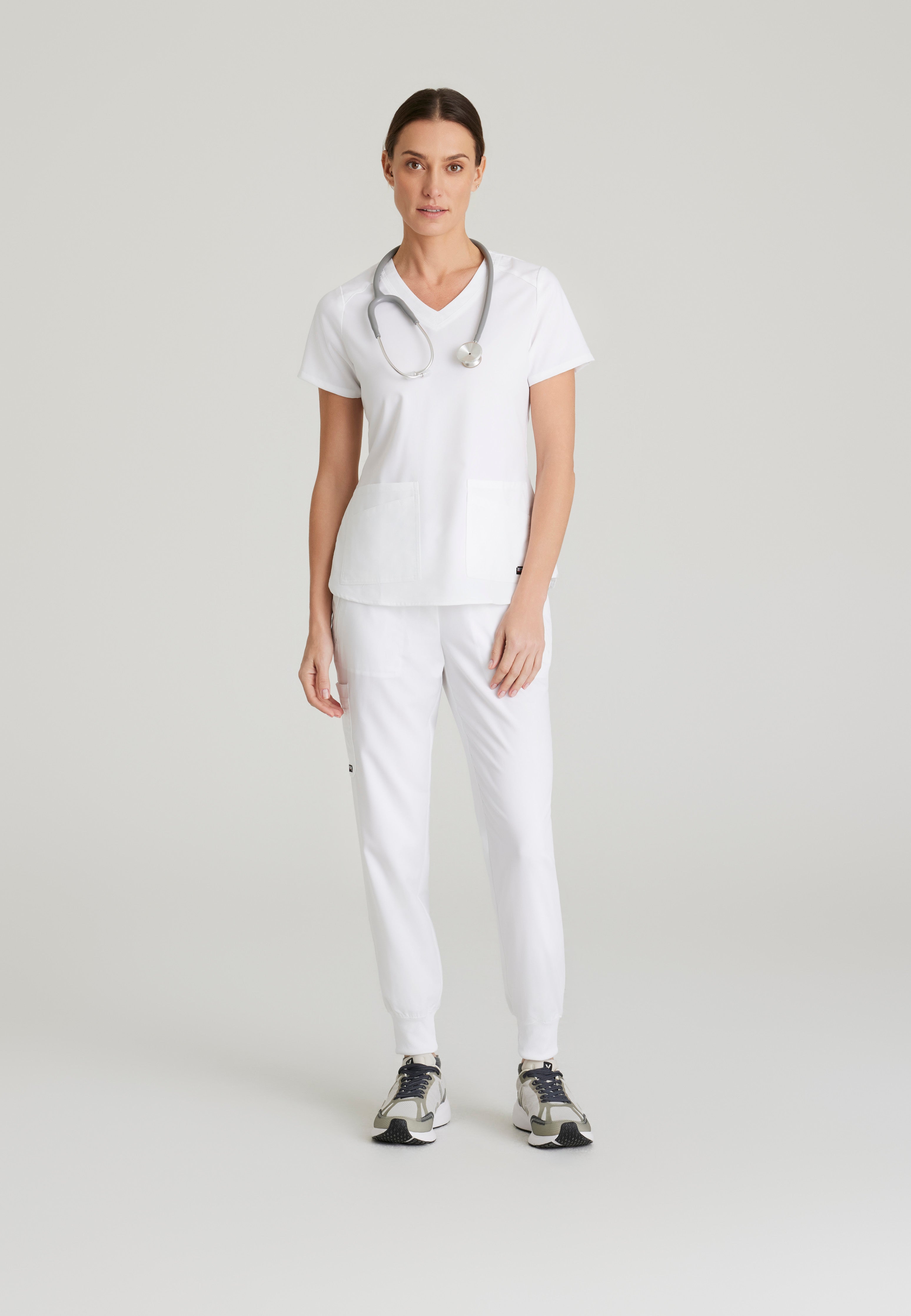 Full Body View of the Emma 4-Pocket V-Neck Scrub Top in White from Grey's Anatomy™ by Barco Spandex Stretch