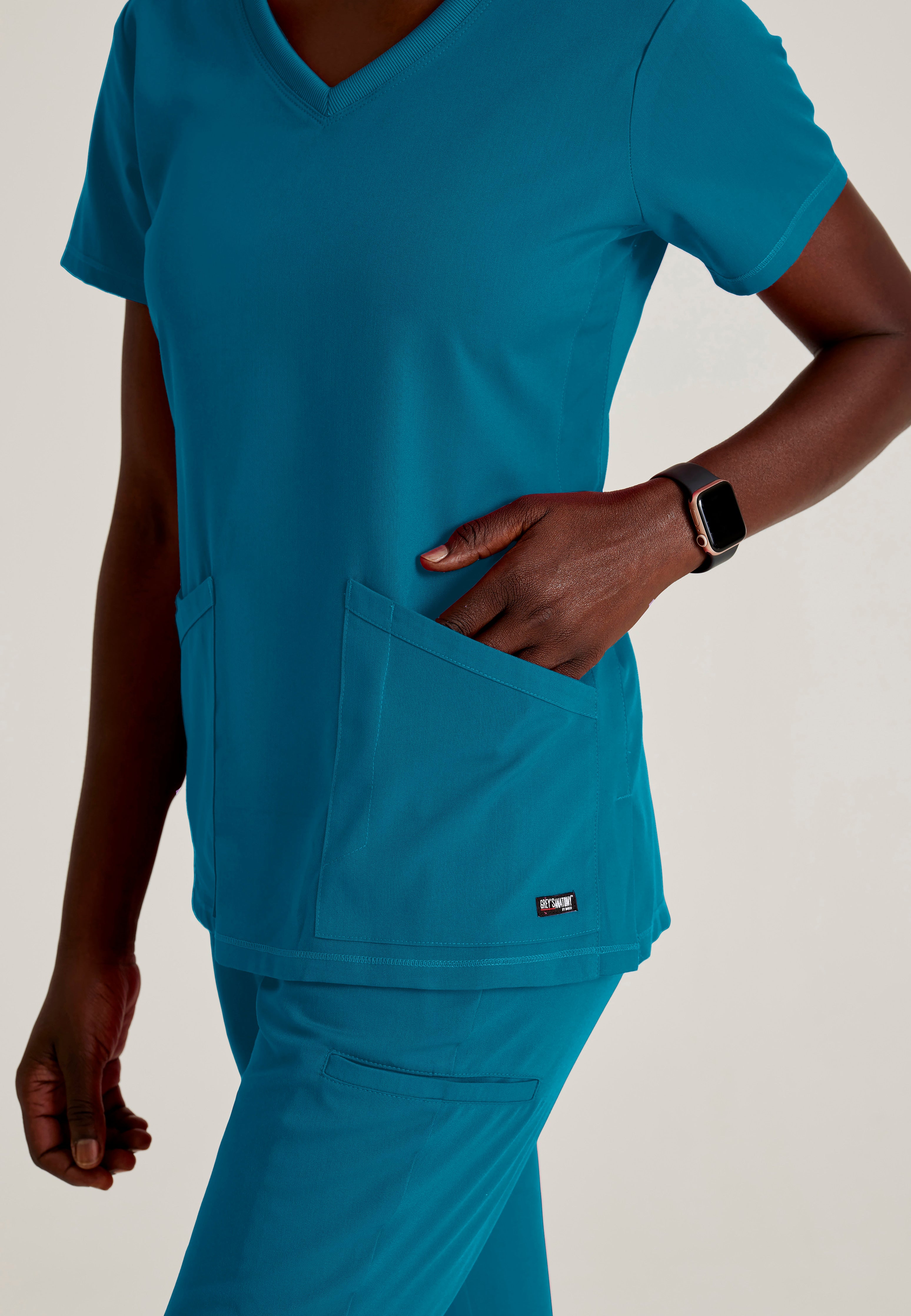 Detail Shot of the Serena 3-Pocket Curved V-Neck Scrub Top in Bahama from Grey's Anatomy™ by Barco Spandex Stretch