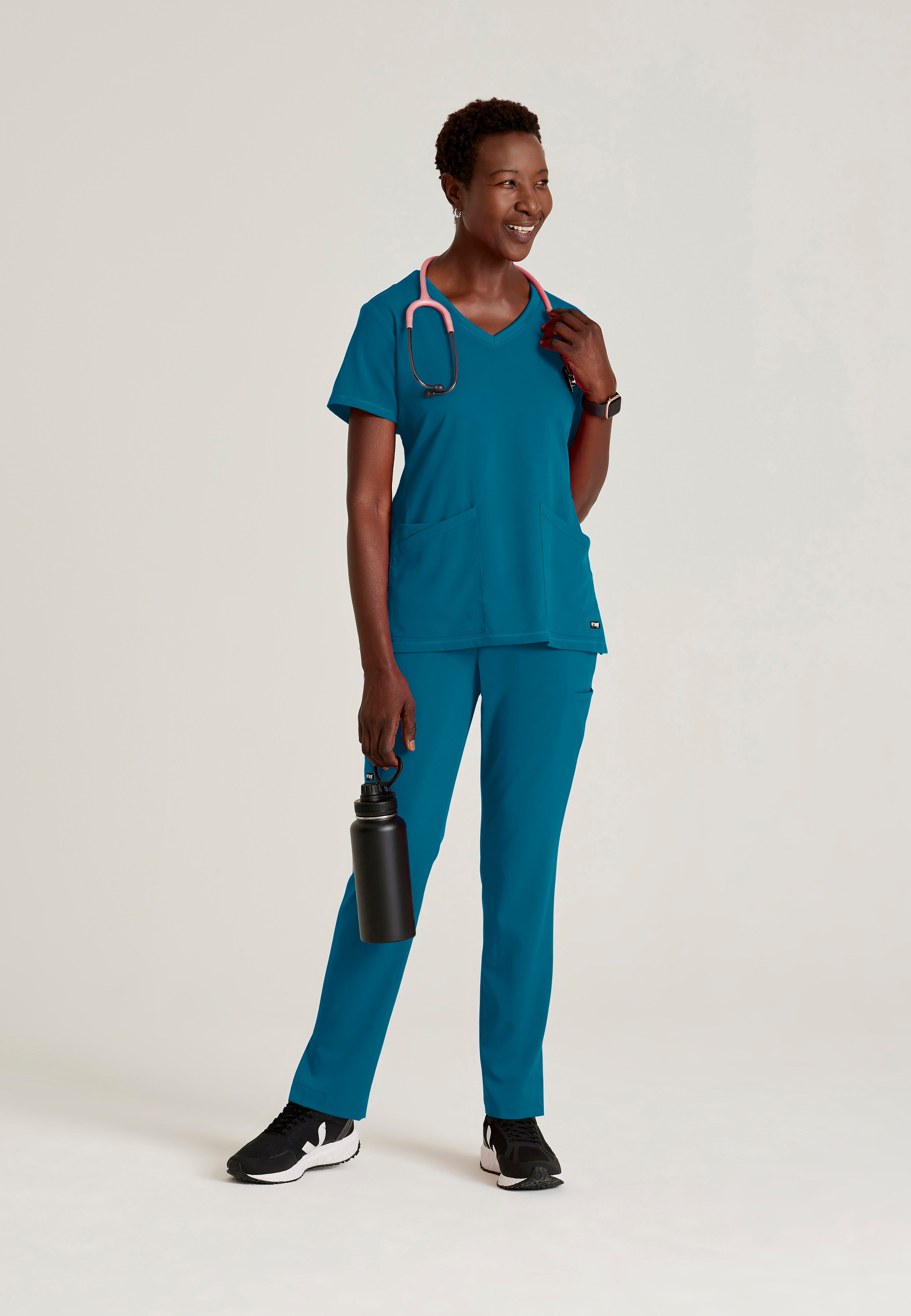 Full Body View of the Serena 3-Pocket Curved V-Neck Scrub Top in Bahama from Grey's Anatomy™ by Barco Spandex Stretch