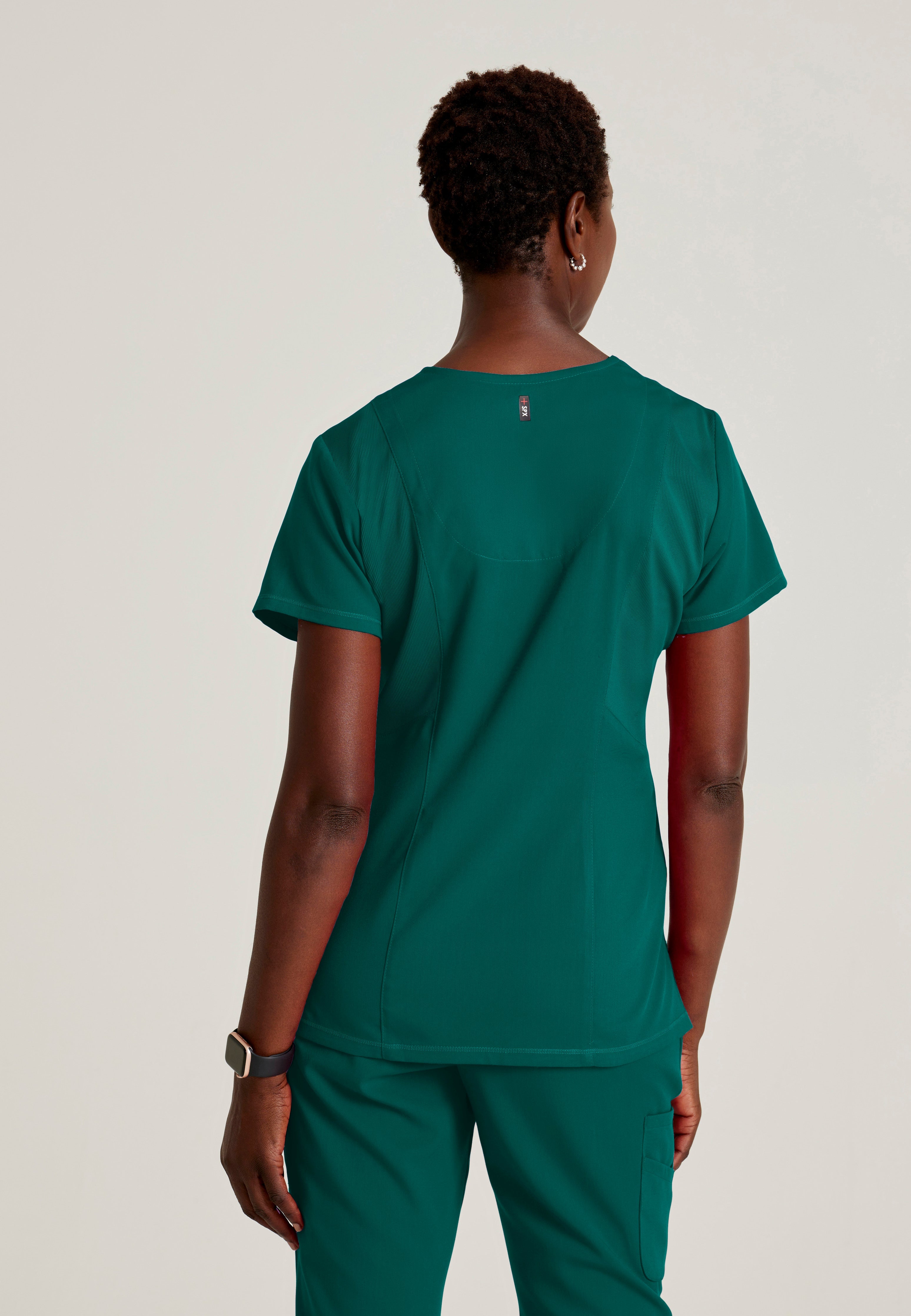 Back View of the Serena 3-Pocket Curved V-Neck Scrub Top in Hunter Green from Grey's Anatomy™ by Barco Spandex Stretch