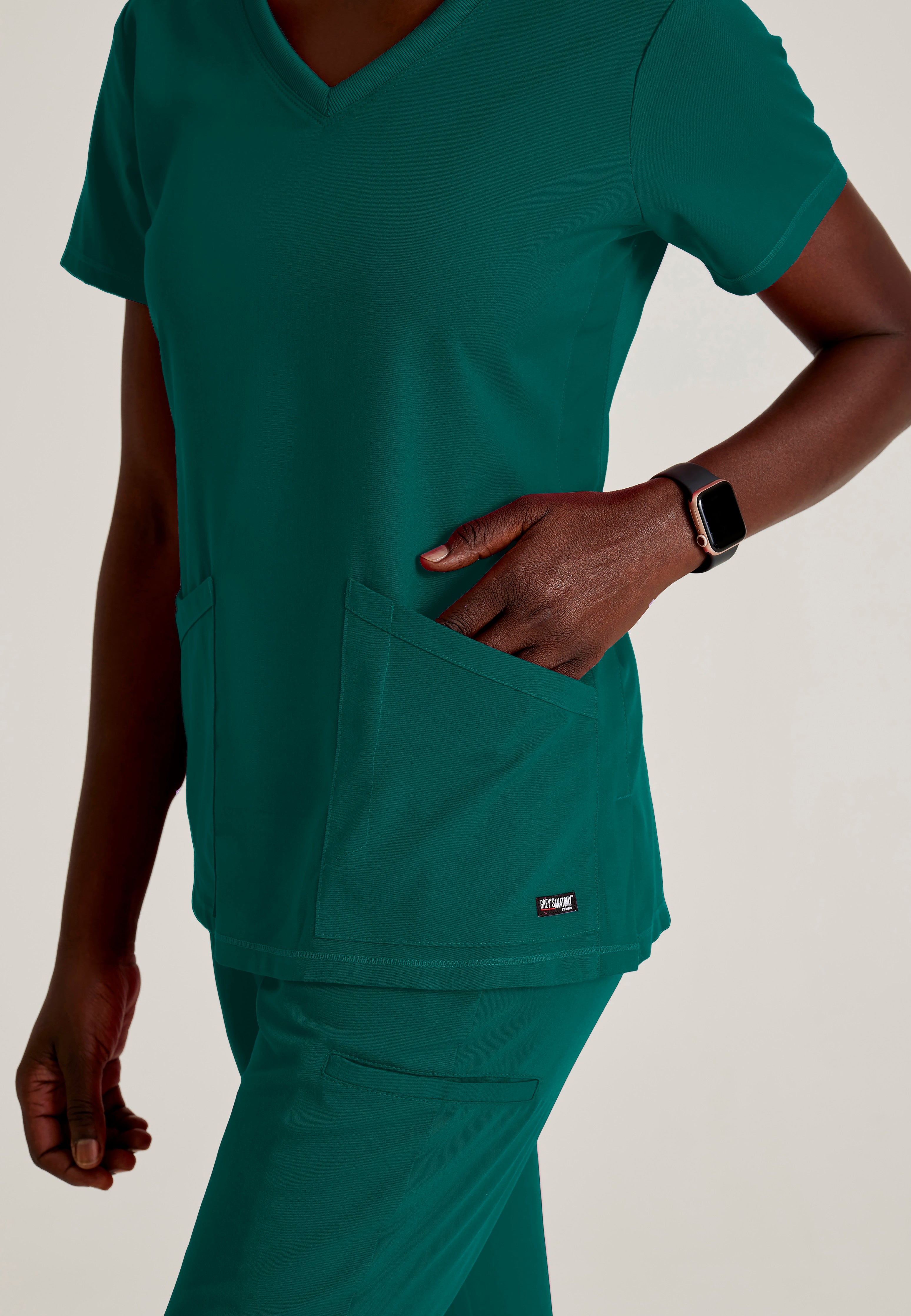 Detail Shot of the Serena 3-Pocket Curved V-Neck Scrub Top in Hunter Green from Grey's Anatomy™ by Barco Spandex Stretch