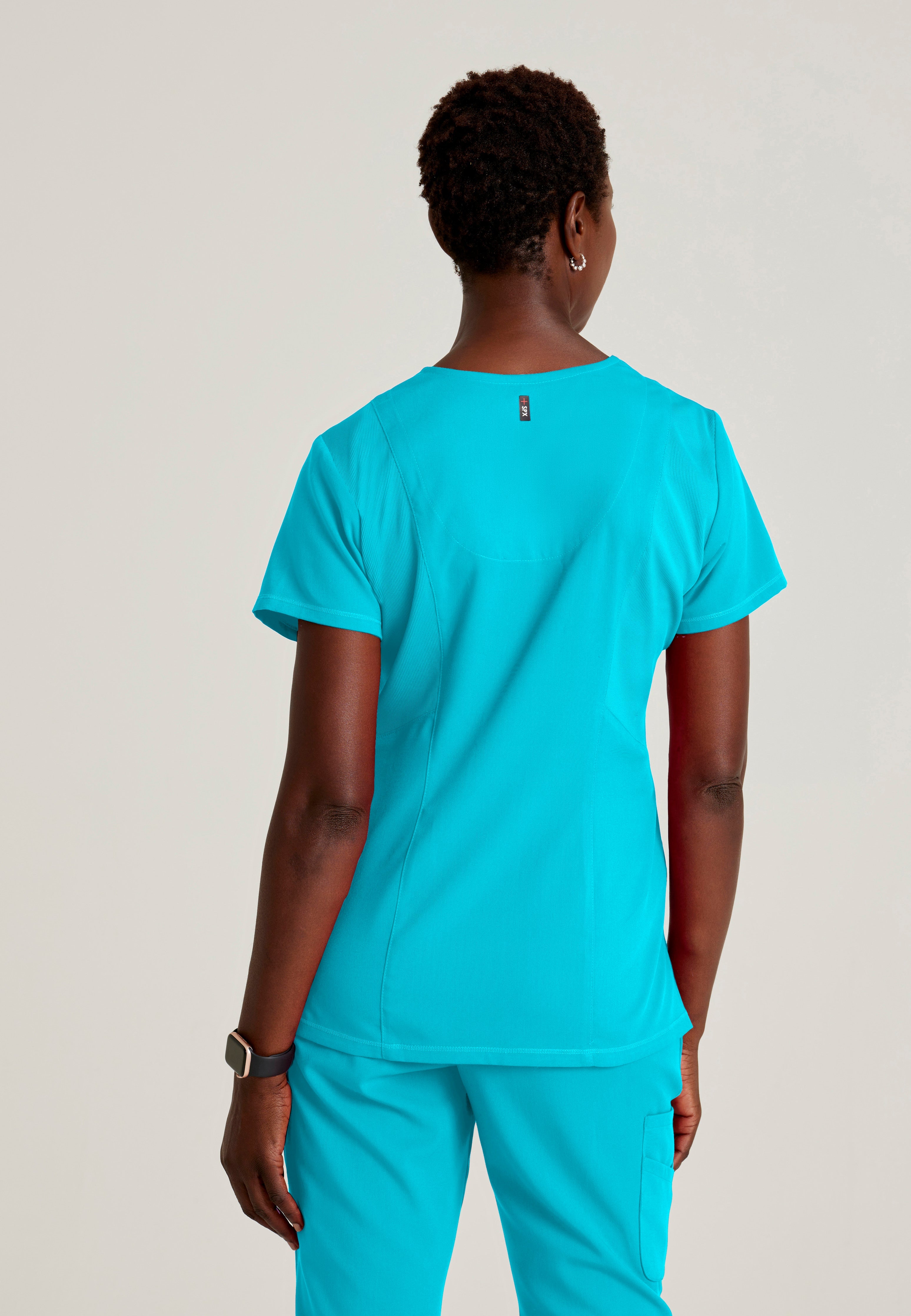Back View of the Serena 3-Pocket Curved V-Neck Scrub Top in Teal from Grey's Anatomy™ by Barco Spandex Stretch