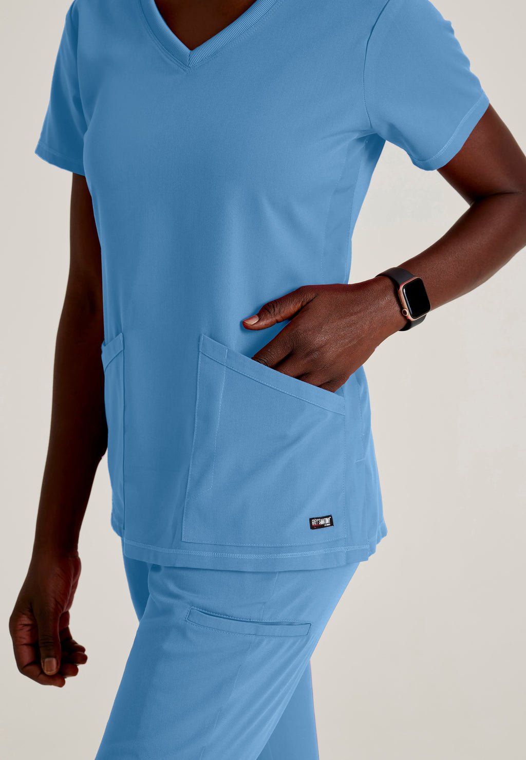 Detail Shot of the Serena 3-Pocket Curved V-Neck Scrub Top in Ciel Blue from Grey's Anatomy™ by Barco Spandex Stretch