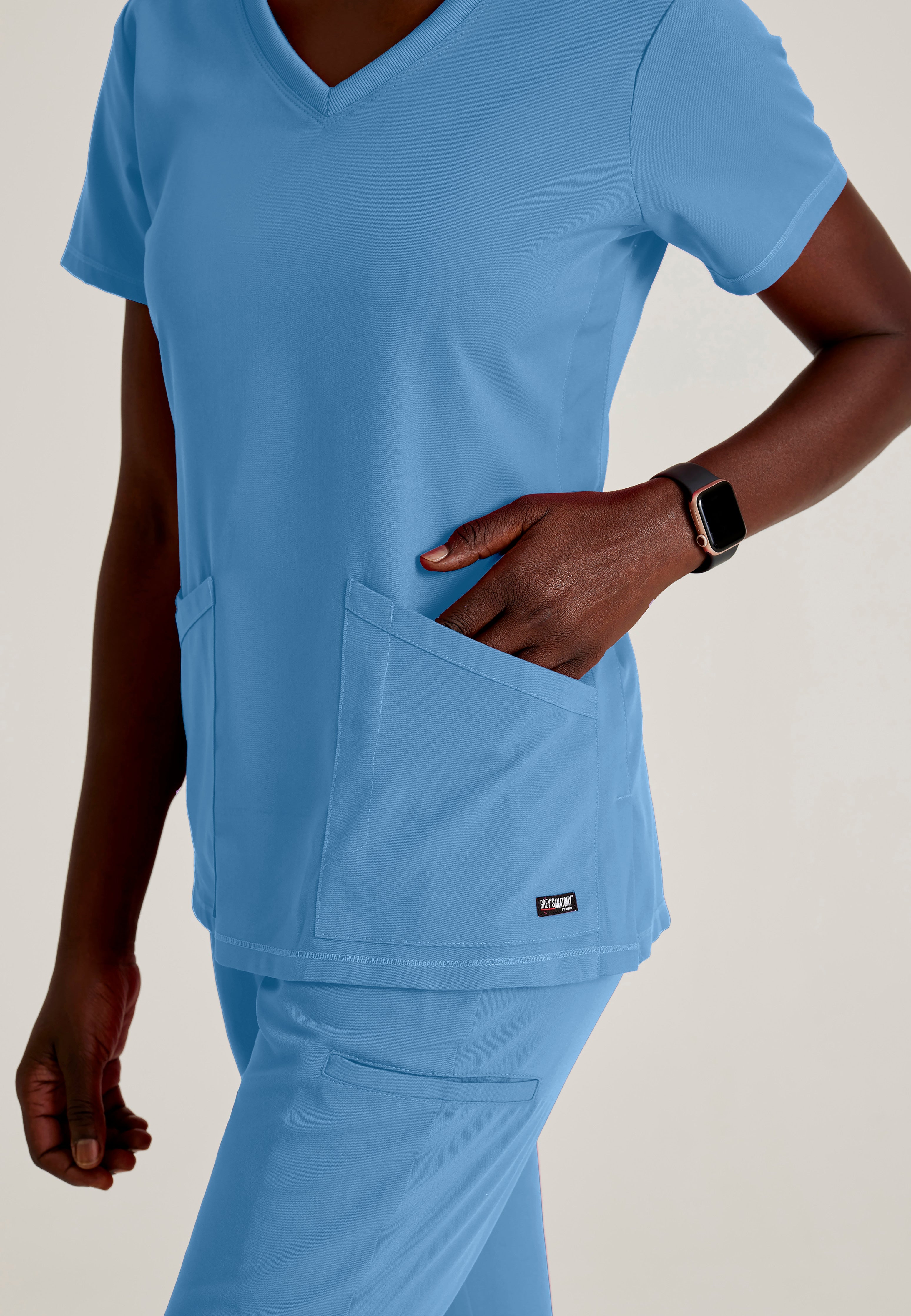 Detail Shot of the Serena 3-Pocket Curved V-Neck Scrub Top in Ciel Blue from Grey's Anatomy™ by Barco Spandex Stretch
