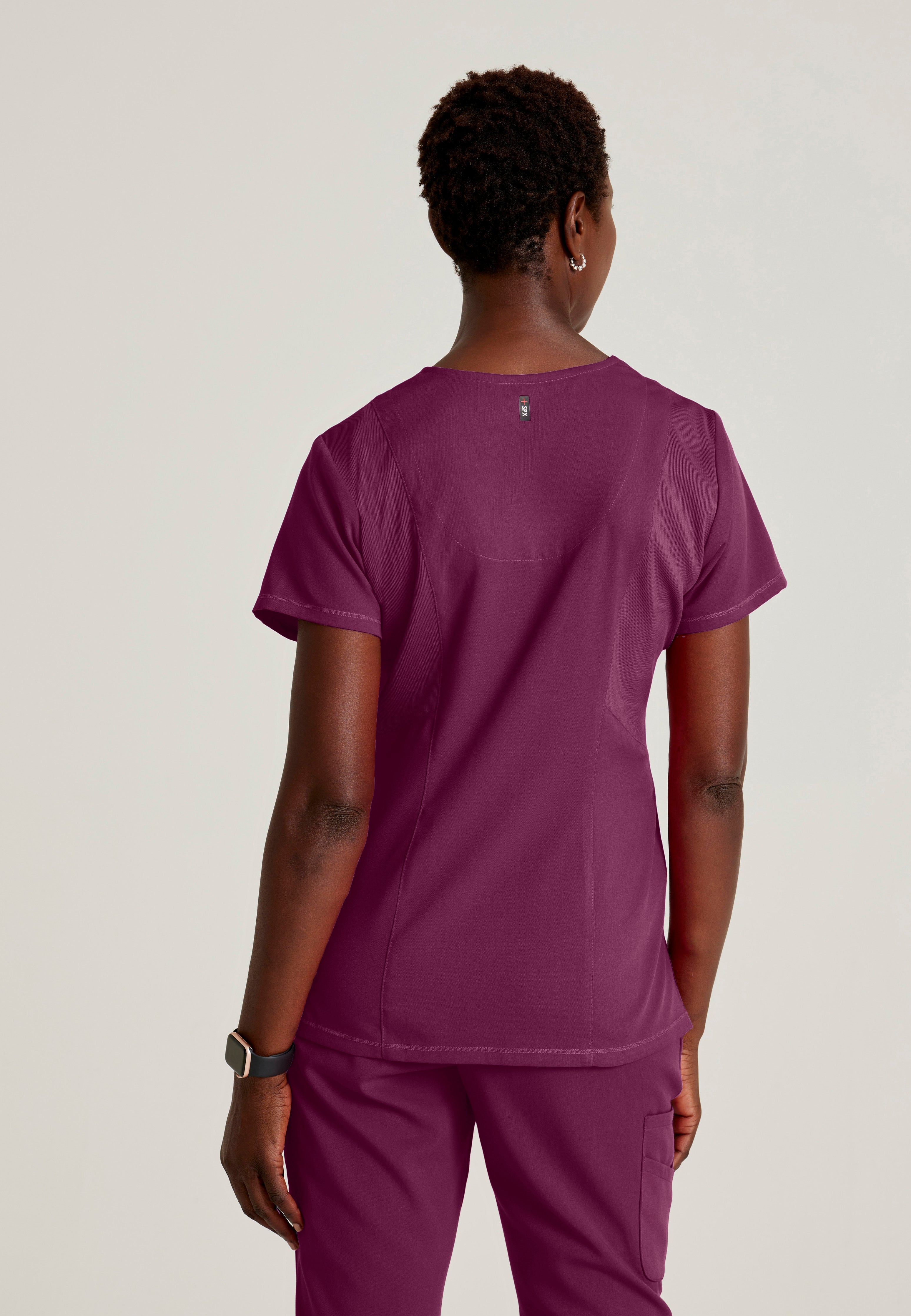 Back View of the Serena 3-Pocket Curved V-Neck Scrub Top in Wine from Grey's Anatomy™ by Barco Spandex Stretch
