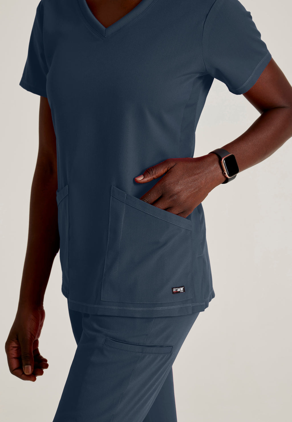 Detail Shot of the Serena 3-Pocket Curved V-Neck Scrub Top in Steel from Grey's Anatomy™ by Barco Spandex Stretch