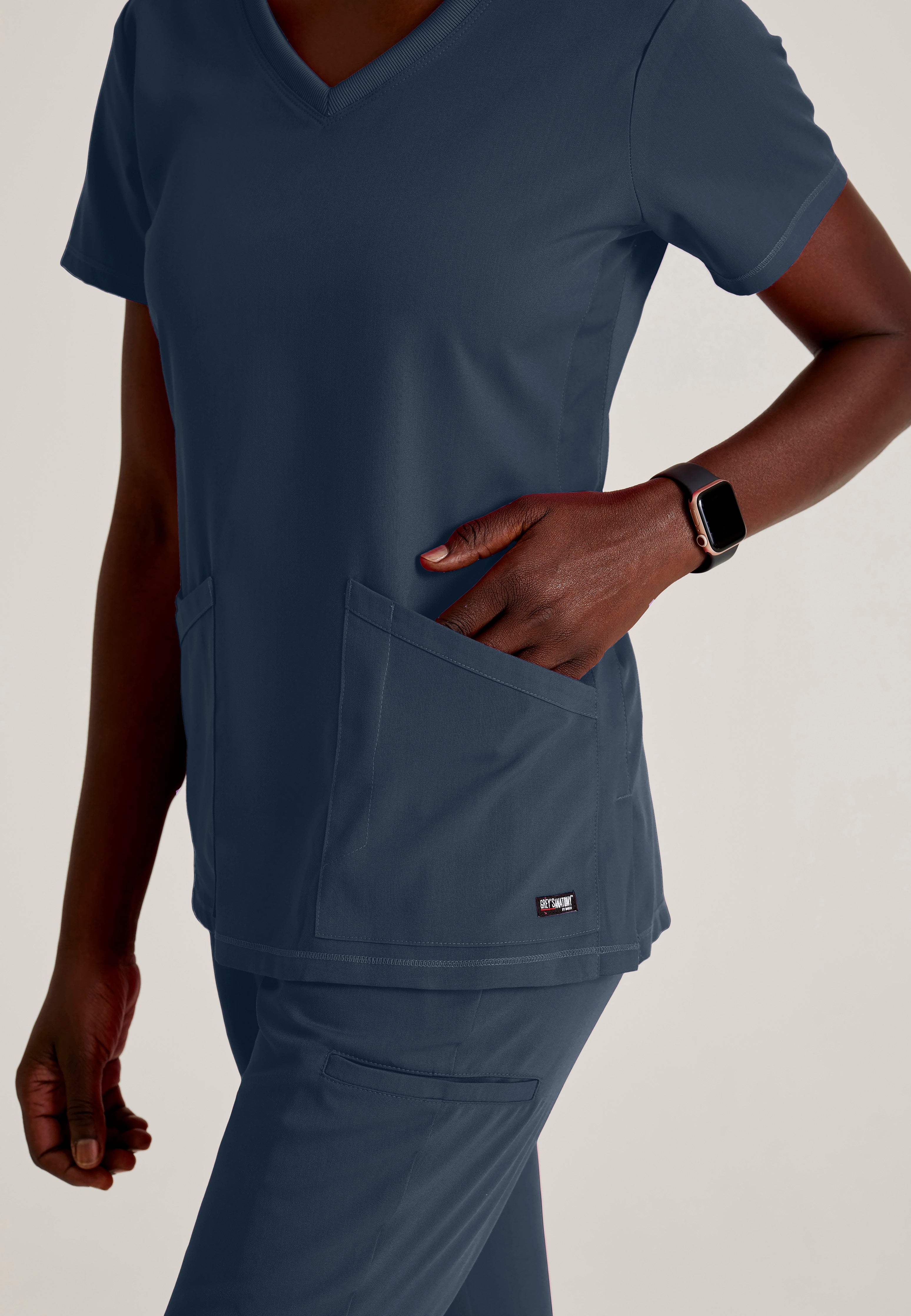 Detail Shot of the Serena 3-Pocket Curved V-Neck Scrub Top in Steel from Grey's Anatomy™ by Barco Spandex Stretch