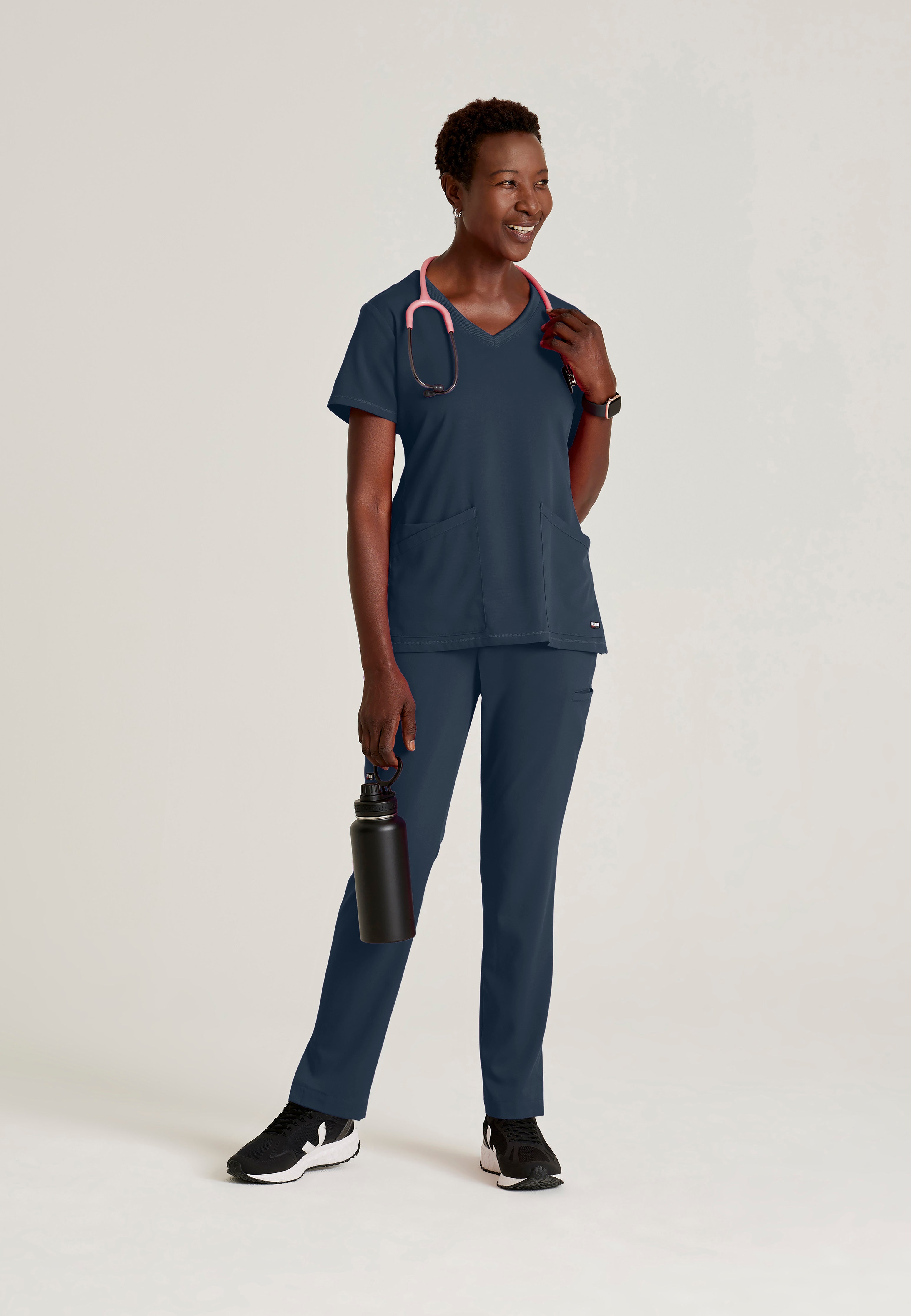 Full Body View of the Serena 3-Pocket Curved V-Neck Scrub Top in Steel from Grey's Anatomy™ by Barco Spandex Stretch